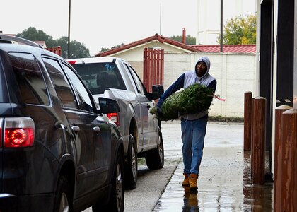 Staff Sgt. Mark Daniels, Assistant NCOIC, Palace Chase, Air Force Personnel Center, carries a Christmas tree as he volunteers to support Trees for Troops at Joint Base San Antonio-Randolph, Texas, Dec. 7, 2018. Since 2005, the organization has collected and donated over 176,000 trees for military families. FedEx has logged over 653,400 miles for this charity in the United States alone. They deliver the Christmas trees to 65 military bases, either in the U.S. or overseas.