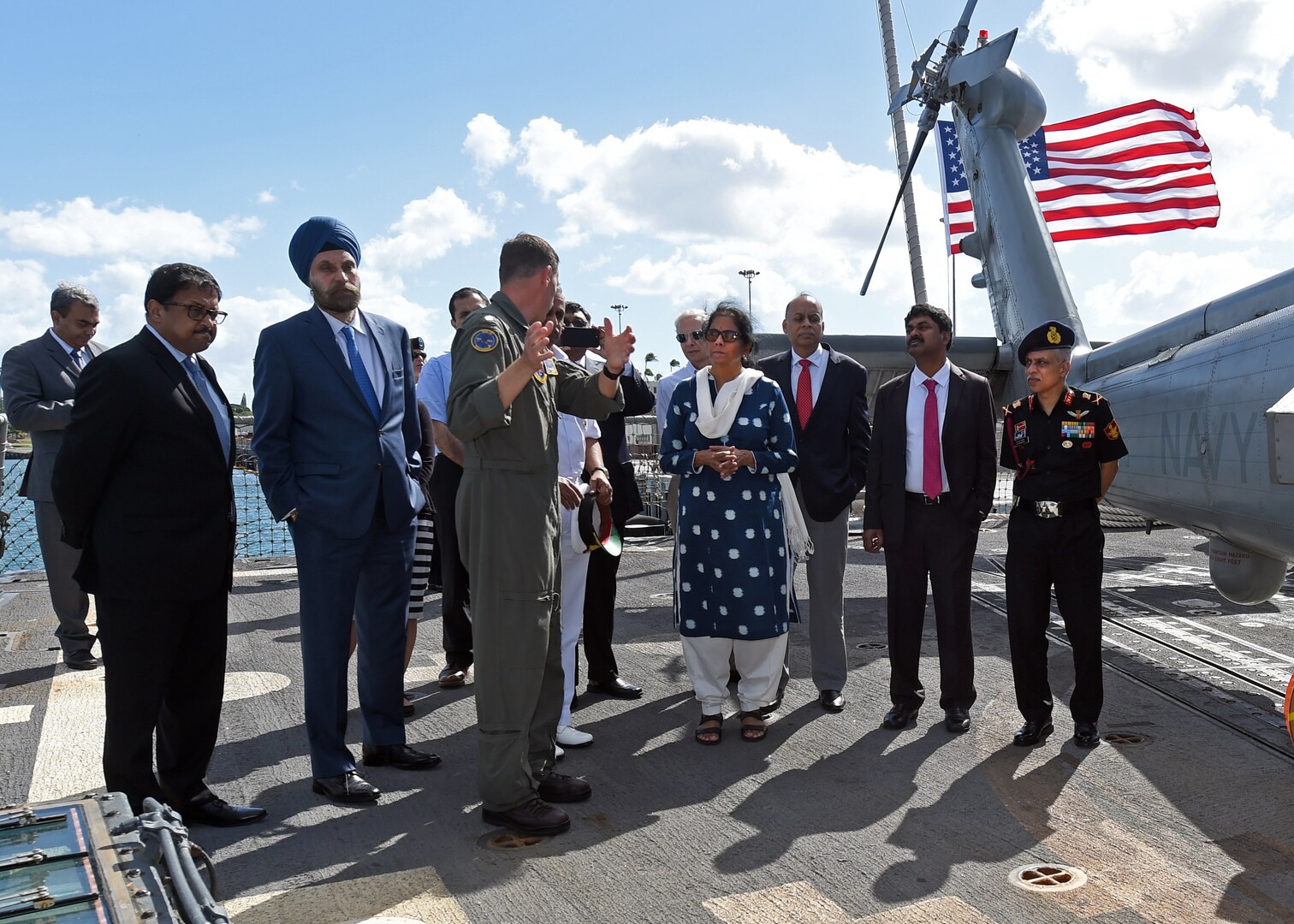 Cmdr. Daniel M. Martins, Executive Officer of the Easyriders Helicopter Maritime Strike Squadron Three Seven (HSM-37), briefs India's Minister of Defence, Nirmala Sitharaman during a tour abroad the USS Michael Murphy. India and the U.S. are global partners in defense and security and are working together to assure a free and open Indo-Pacific.
