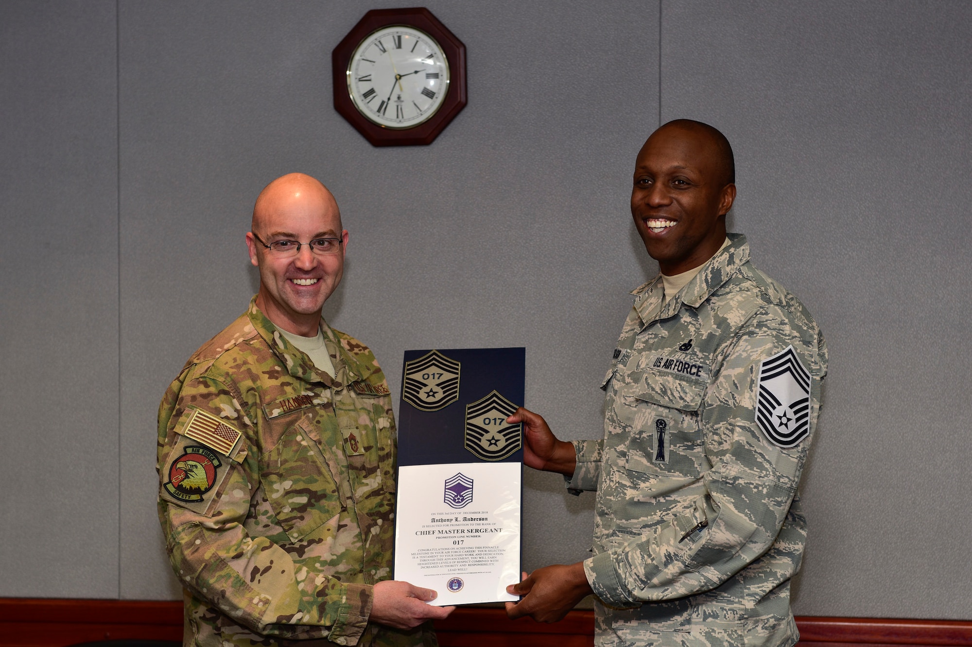 Chief Master Sgt. Joshua Hansen, Air Force Safety Center aircraft mishap investigator, informs Senior Master Sgt. Anthony Anderson, Air Force Safety Center’s Weapons Safety Division superintendent, of his selection for promotion to chief master sergeant at Kirtland Air Force Base, N.M., Dec. 6, 2018. The senior master sergeants selected for chief will be promoted starting January 2019, according to their promotion sequence number. (U.S. Air Force photo by Airman 1st Class Austin J. Prisbrey)