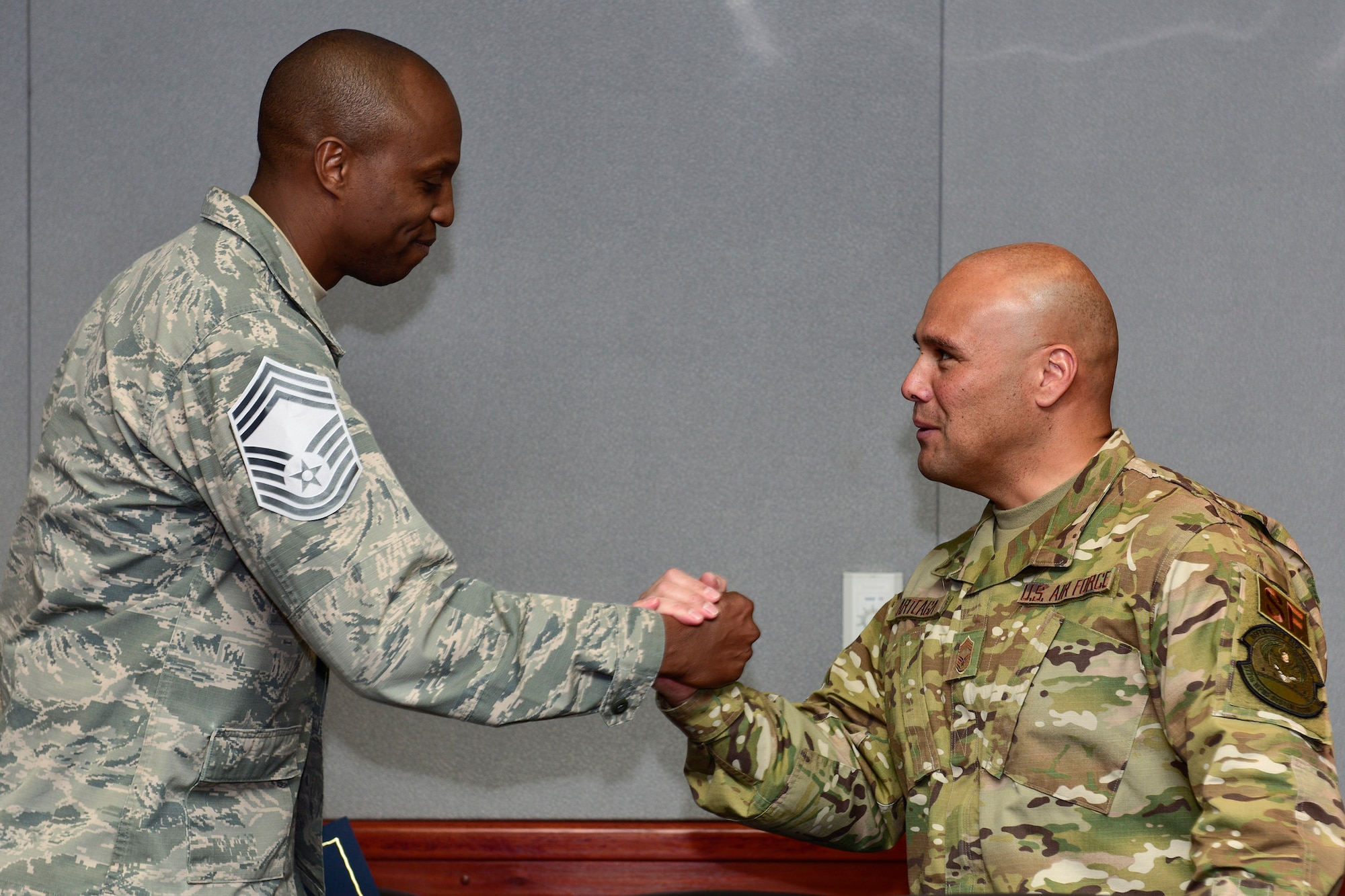 Chief Master Sgt. Roberto Arteaga, 377th Weapons System Security Squadron security forces manager, welcomes Senior Master Sgt. Anthony Anderson, Air Force Safety Center’s Weapons Safety Division superintendent, to the Kirtland Chief’s Group at Kirtland Air Force Base, N.M., Dec. 6, 2018. The Air Force selected 479 senior master sergeants for promotion to chief master sergeant out of 2,241 eligible with a selection rate of 21.37 percent for this promotion cycle. (U.S. Air Force photo by Airman 1st Class Austin J. Prisbrey)