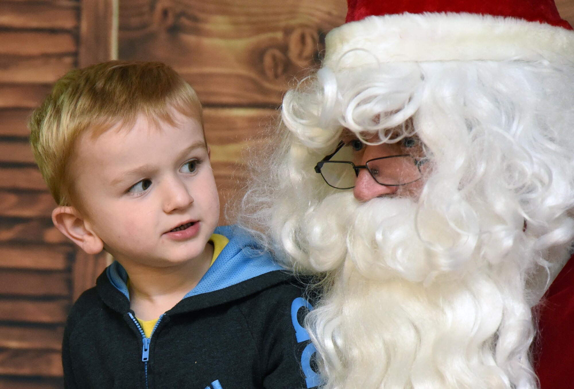 Logan Partin, son of U.S. Air Force Master Sgt. Troy Partin, 334th Training Squadron course developer writer, visits with Santa during Christmas in the Park at Keesler Air Force Base, Mississippi, Dec. 6, 2018. The event hosted by Outdoor Recreation included cookie and ornament decorating, games and visits with Santa. (U.S. Air Force photo by Kemberly Groue)