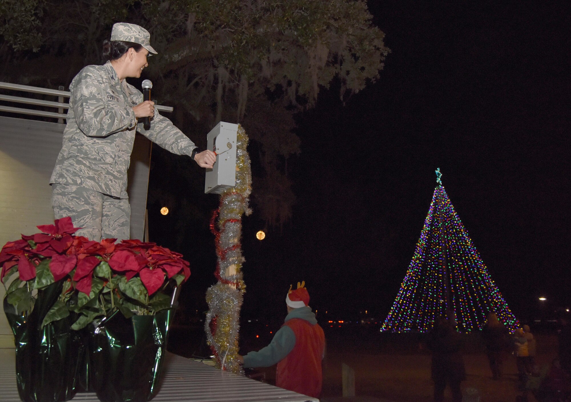 U.S Air Force Col. Debra Lovette, 81st Training Wing commander, turns on the lights during a Christmas tree lighting ceremony at Christmas in the Park on Keesler Air Force Base, Mississippi, Dec. 6, 2018. The event hosted by Outdoor Recreation included cookie and ornament decorating, games and visits with Santa. (U.S. Air Force photo by Kemberly Groue)