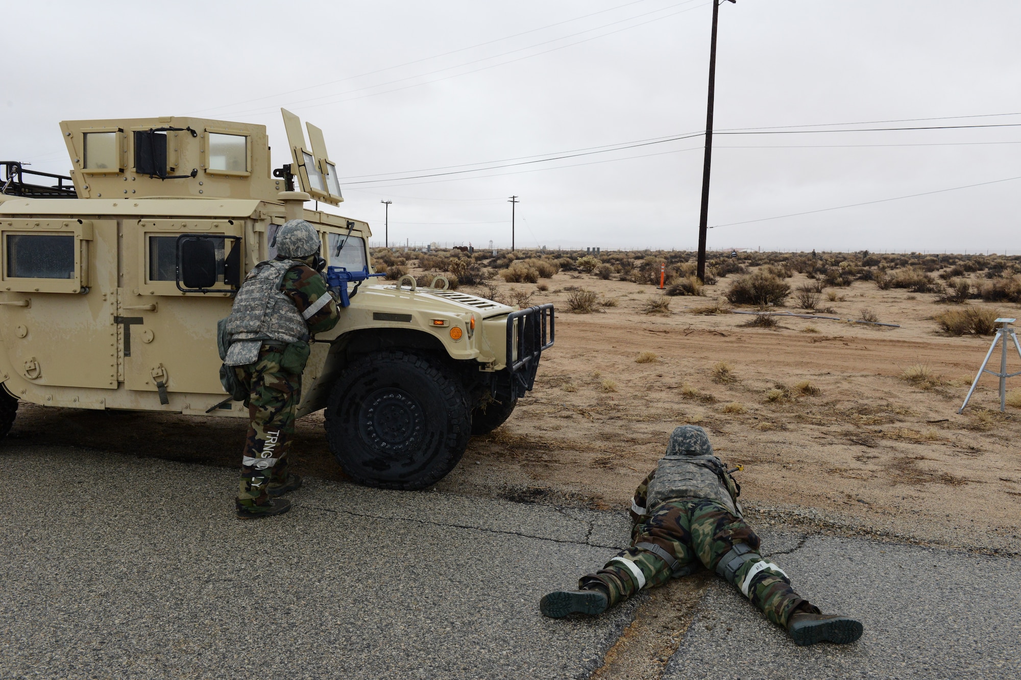 Airmen take cover from simulated enemy fire at North Base during the latest readiness exercise Dec. 6. (U.S. Air Force photo by Kenji Thuloweit)