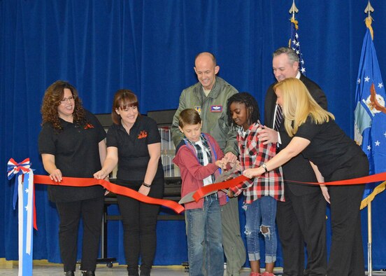 Members of the new STARBASE staff wearing the black shirts (left to right): Lourdes Talamantez, Caitlin Craig and Janet Creech, join fifth grade students Ananda and William, along with Brig. Gen. E. John Teichert, 412th Test Wing commander (center back), and Mike O’Toole, Department of Defense STARBASE program, in the ceremonial ribbon cutting to officially open STARBASE at Branch Elementary on Edwards Air Force Base. (U.S. Air Force photo by Kenji Thuloweit)