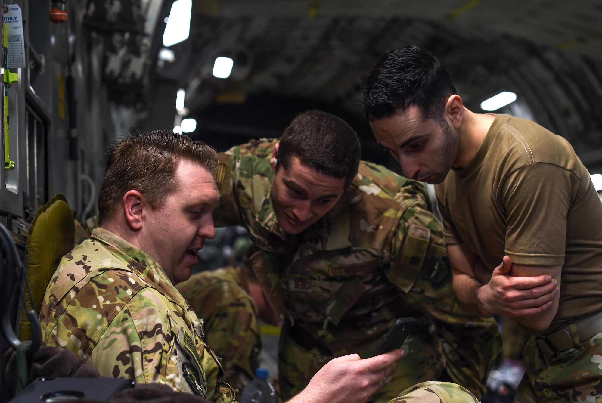 Staff Sgt. John Nieves Camacho, right, 627th Air Base Group religious affairs specialist, talks with Staff Sgt. Cameron Morris, left, 4th Airlift Squadron loadmaster, and Capt. Alexander Jobrack, middle, 62nd Medical Squadron flight surgeon, inside a C-17 Globemaster III at Rota Naval Station, Spain, Nov. 28, 2018. Camacho was part of a religious support team that flew with deploying and returning Airmen to offer any assistance they may need during the flights to and from Ali Al Salem Air Base, Kuwait, and Al Udeid Air Base, Qatar. (U.S. Air Force photo by Senior Airman Tryphena Mayhugh)