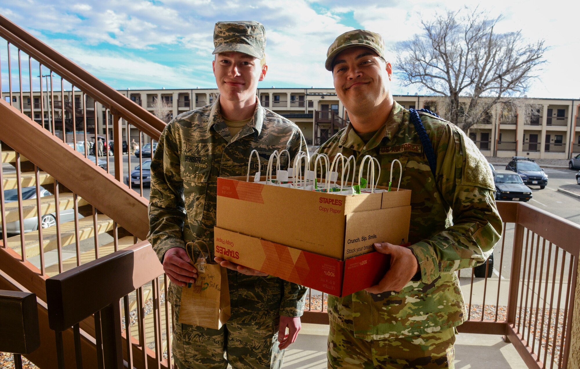 Staff Sgt. Edward Scoby distributes a bag of cookies to Airman 1st Class Robert Benson at the dormitories during the annual cookie drive here. 
Seven hundred and eight-two dozen cookies were baked, donated, and/or collected and coordinated by the Kirtland Spouses Club Dec. 5 and 6. They were then delivered by the First Sergeants Council and additional volunteers to dormitory residents Dec. 6. The annual cookie drive, a tradition kept alive year after year by the work of the Spouses Club, ensures that Airmen living in the dormitories have homemade holiday treats. More than 30 Spouses Club members were joined by active duty volunteers to collect and package the cookies. (Photos by Jessie Perkins)