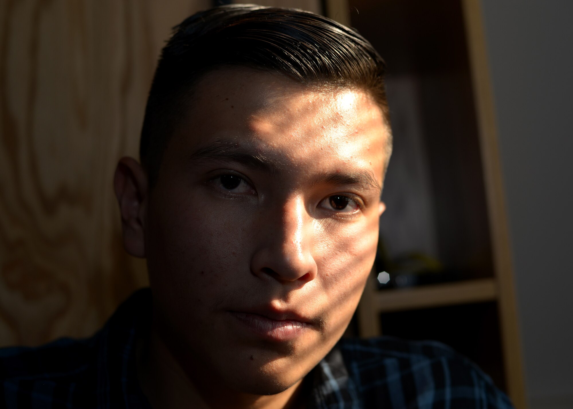 Airman 1st Class Phillip E. Rock, a B-2 weapons load crew member assigned to the 509th Aircraft Maintenance Squadron, poses for a portrait.