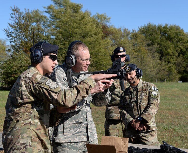 Senior Airman Anthony M. Bailey, a combat arms instructor assigned to the 509th Security Forces Squadron, familiarizes Maj. Gen. James C. Dawkins Jr., Eighth Air Force commander, with the M320 grenade launcher.