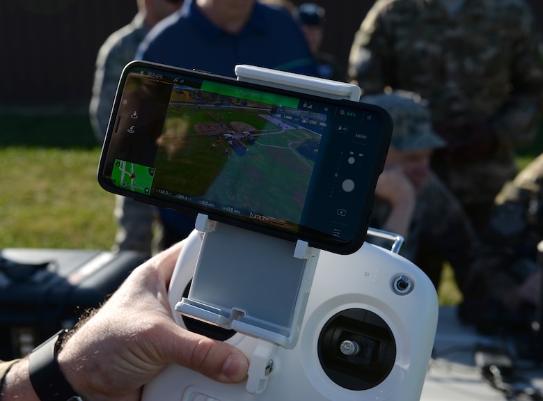 Master Sgt. Christopher S. Camara, Weapons System Security NCOIC assigned to the 509th Security Forces Squadron, uses a remote controller and cellphone to control a drone.