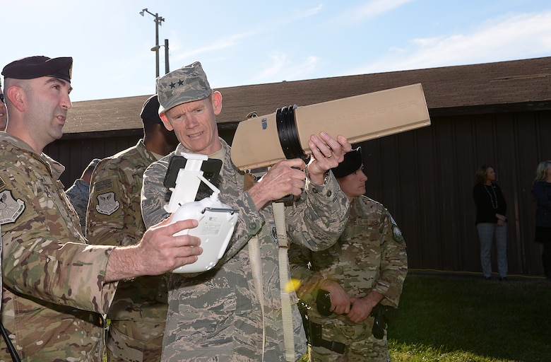 Maj. Gen. James C. Dawkins Jr., Eighth Air Force commander, learns about anti-drone technology from Master Sgt. Christopher S. Camara.