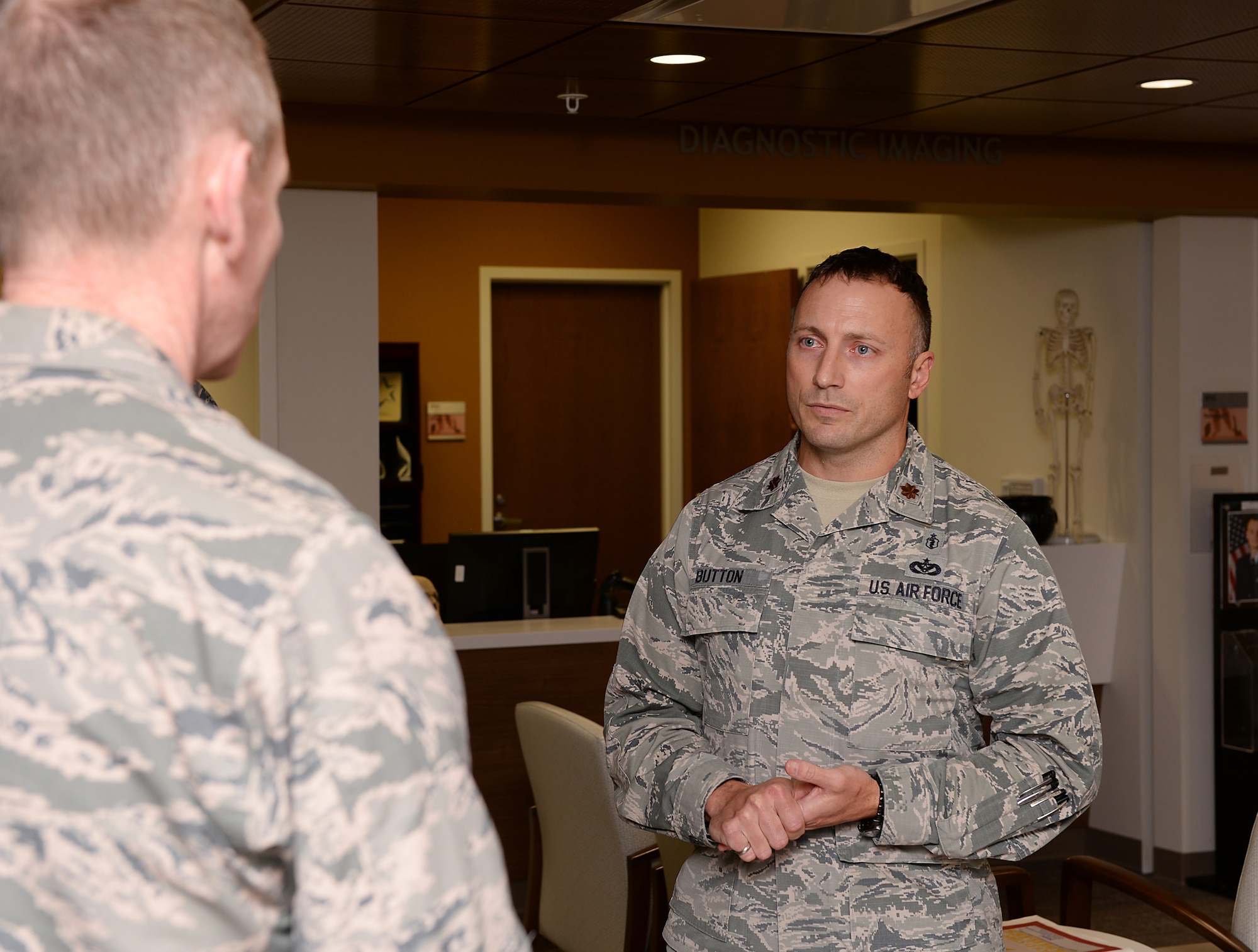 Maj. Christopher J. Button, commander of the 509th Medical Group mental health flight, briefs Maj. Gen. James C. Dawkins Jr.
