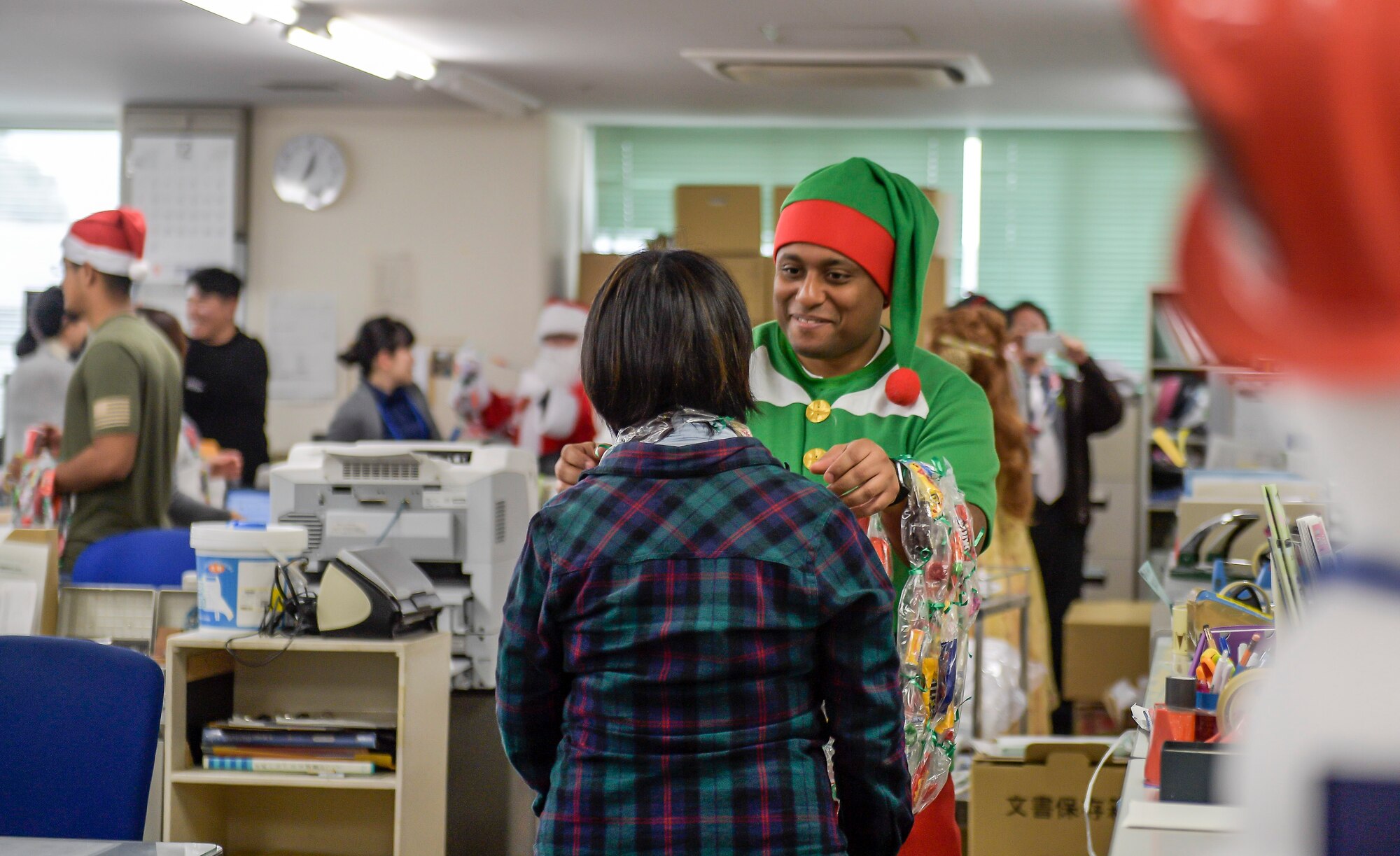 A Yokota Air Base, Japan, member gives a candy lei to a staff member