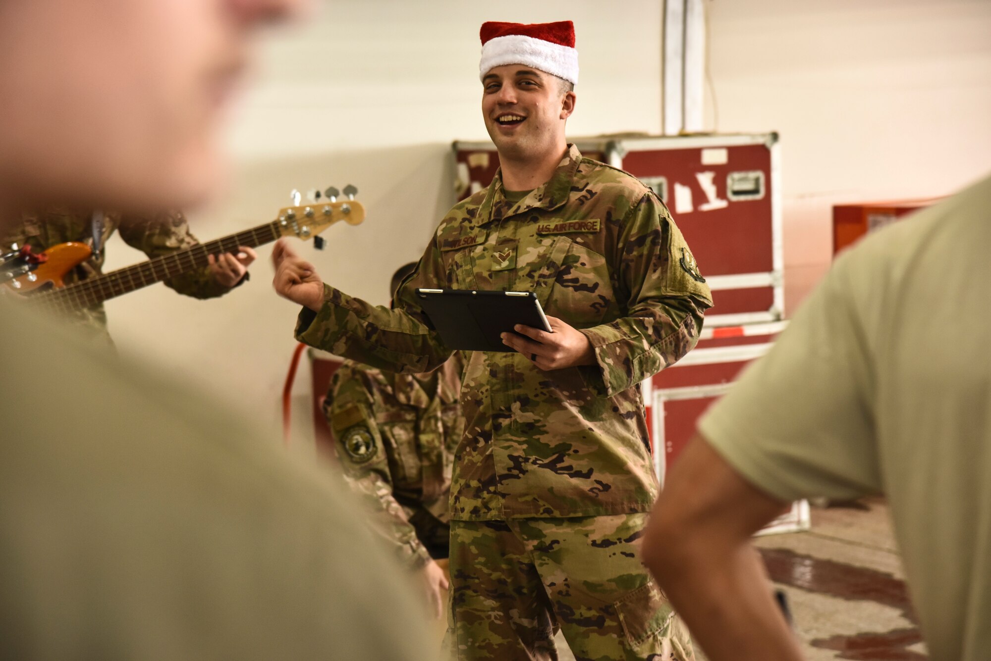 U.S. Air Force Senior Airman Derek Wilson, U.S. Air Forces Central Command Band vocalist, performs at Al Dhafra Air Base, United Arab Emirates, Dec. 4, 2018. The AFCENT Band rotates several ensembles through the area of responsibility that perform a wide variety of musical styles to appeal to audiences of all ages and backgrounds. (U.S. Air Force photo by Senior Airman Mya M. Crosby)