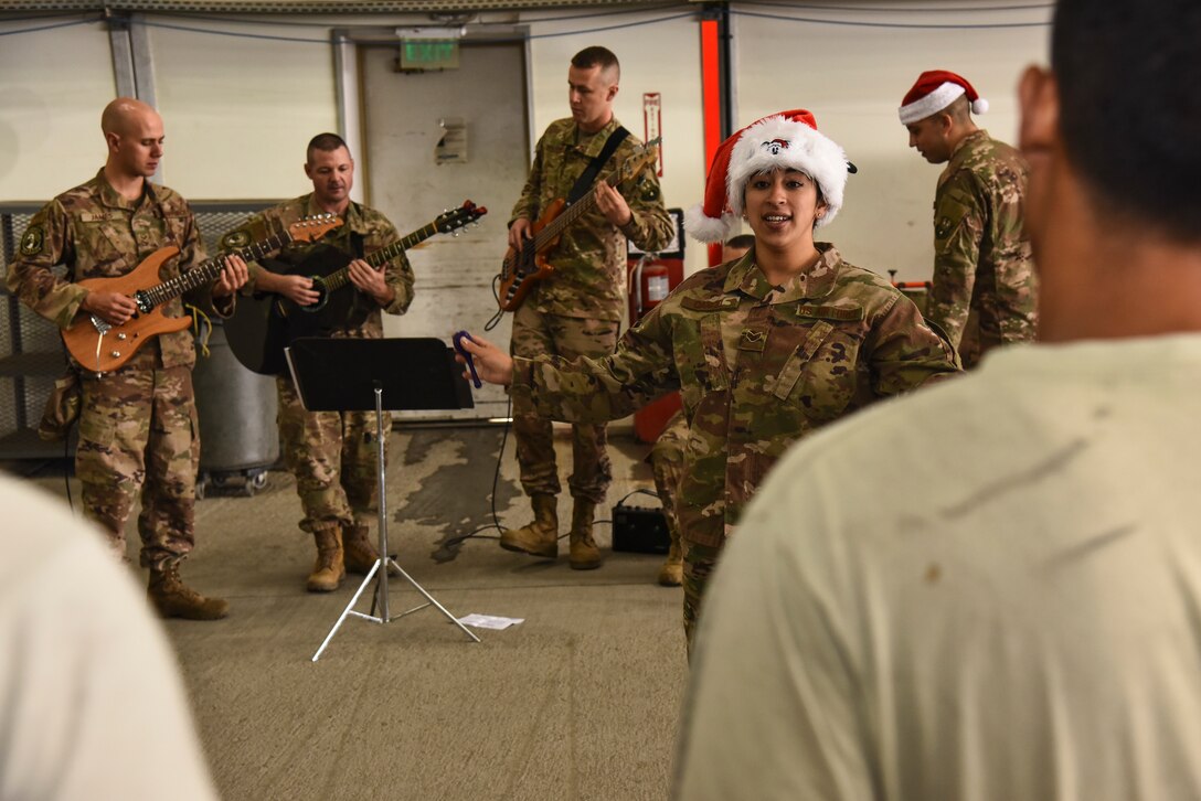 U.S. Air Force Senior Airman Alycia Cancel, U.S. Air Forces Central Command Band vocalist, performs at Al Dhafra Air Base, United Arab Emirates, Dec. 4, 2018. The AFCENT Band rotates several ensembles through the area of responsibility that perform a wide variety of musical styles to appeal to audiences of all ages and backgrounds. (U.S. Air Force photo by Senior Airman Mya M. Crosby)