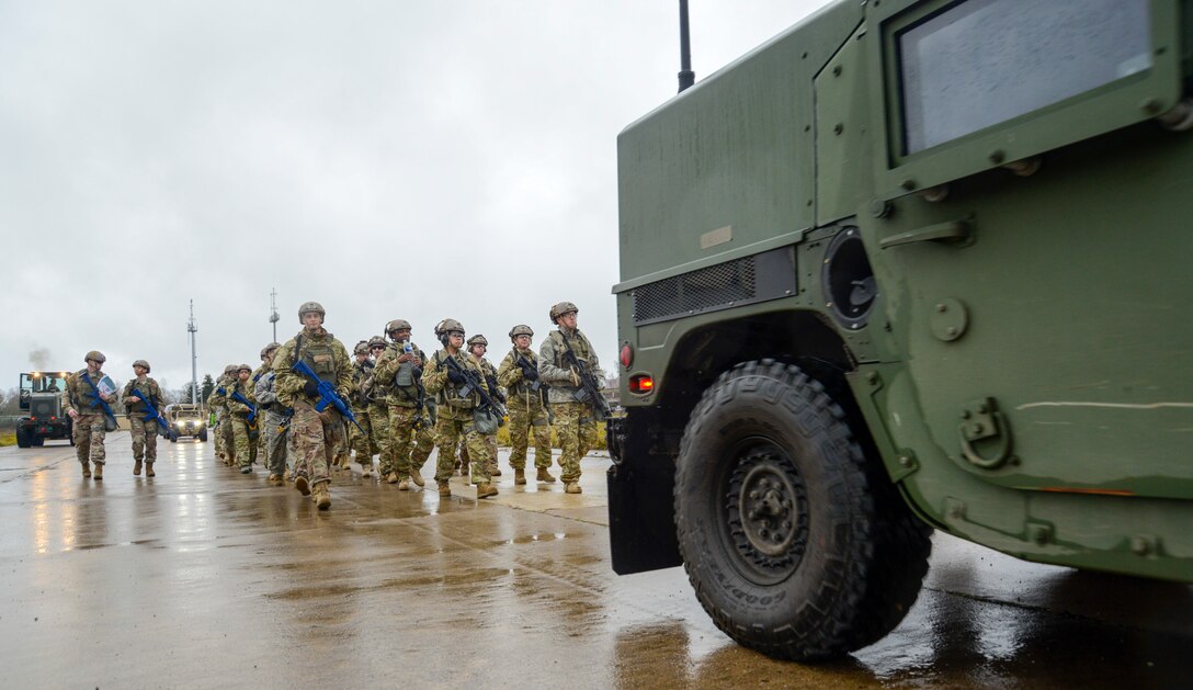 U.S. Airmen assigned to the 435th Contingency Response Group, 435th Air Ground Operations Wing, Ramstein Air Base, Germany, march to the location of their bare base site during exercise Contested Forge on Grostenquin Air Base, France, Dec. 3, 2018. Contested Forge is an annual exercise that tests the 435th CRG's ability to build a forward operating base and conduct airfield operations in an austere environment, friendly or hostile. (U.S. Air Force photo by Staff Sgt. Timothy Moore)