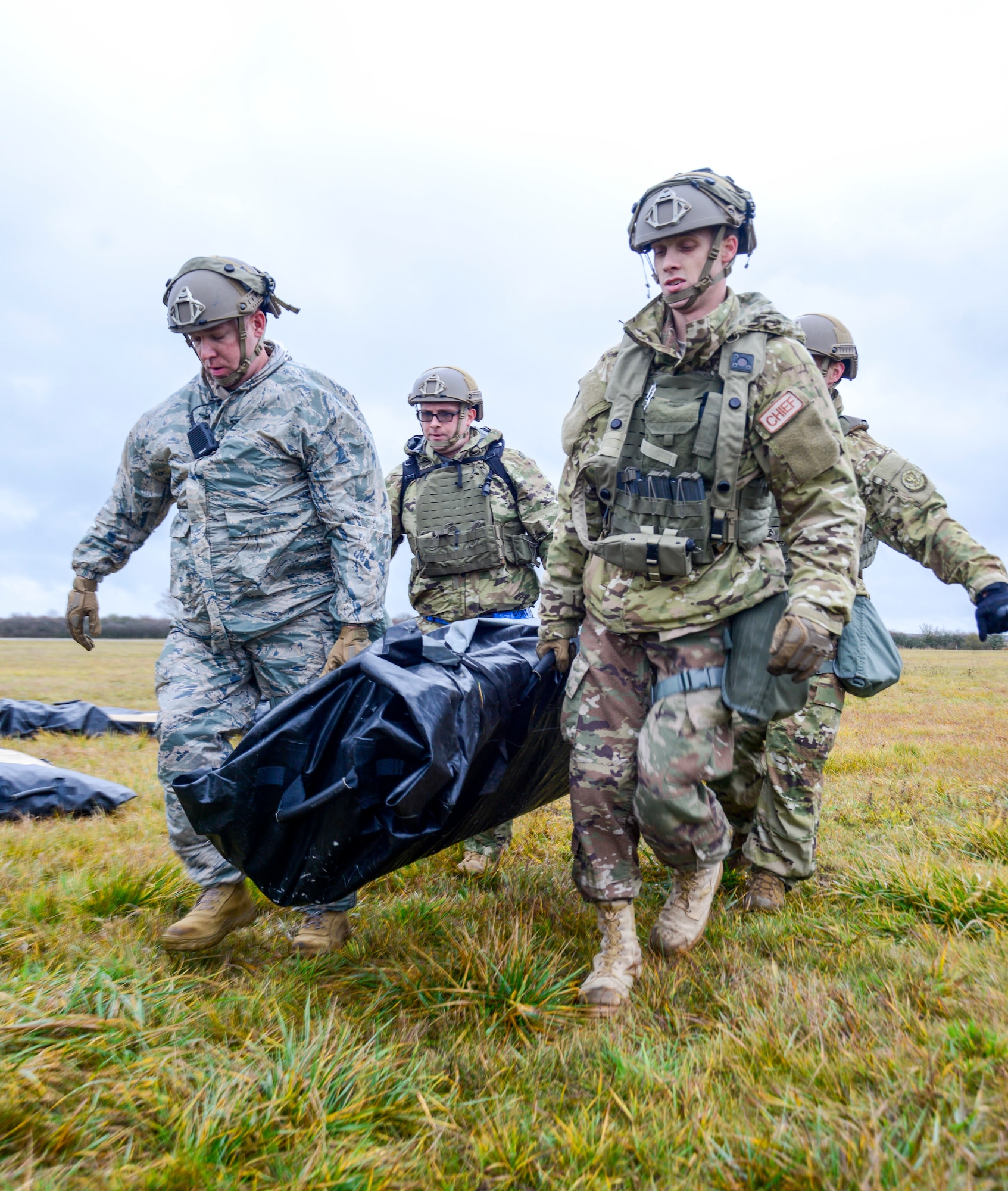 U.S. Airmen assigned to the 435th Contingency Response Group, 435th Air Ground Operations Wing, Ramstein Air Base, Germany, carry a Tent Model 60 bag during exercise Contested Forge on Grostenquin Air Base, France, Dec. 3, 2018. Contested Forge is an annual exercise that tests the 435th CRG's ability to build a forward operating base and conduct airfield operations in an austere environment, friendly or hostile. (U.S. Air Force photo by Staff Sgt. Timothy Moore)