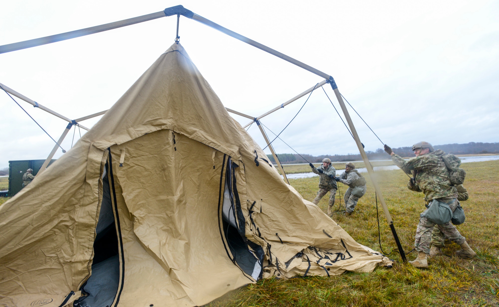 U.S. Airmen assigned to the 435th Contingency Response Group, 435th Air Ground Operations Wing, Ramstein Air Base, Germany, build a Tent Model 60 during exercise Contested Forge on Grostenquin Air Base, France, Dec. 3, 2018. Contested Forge is an annual exercise that tests the 435th CRG's ability to build a forward operating base and conduct airfield operations in an austere environment, friendly or hostile. (U.S. Air Force photo by Staff Sgt. Timothy Moore)