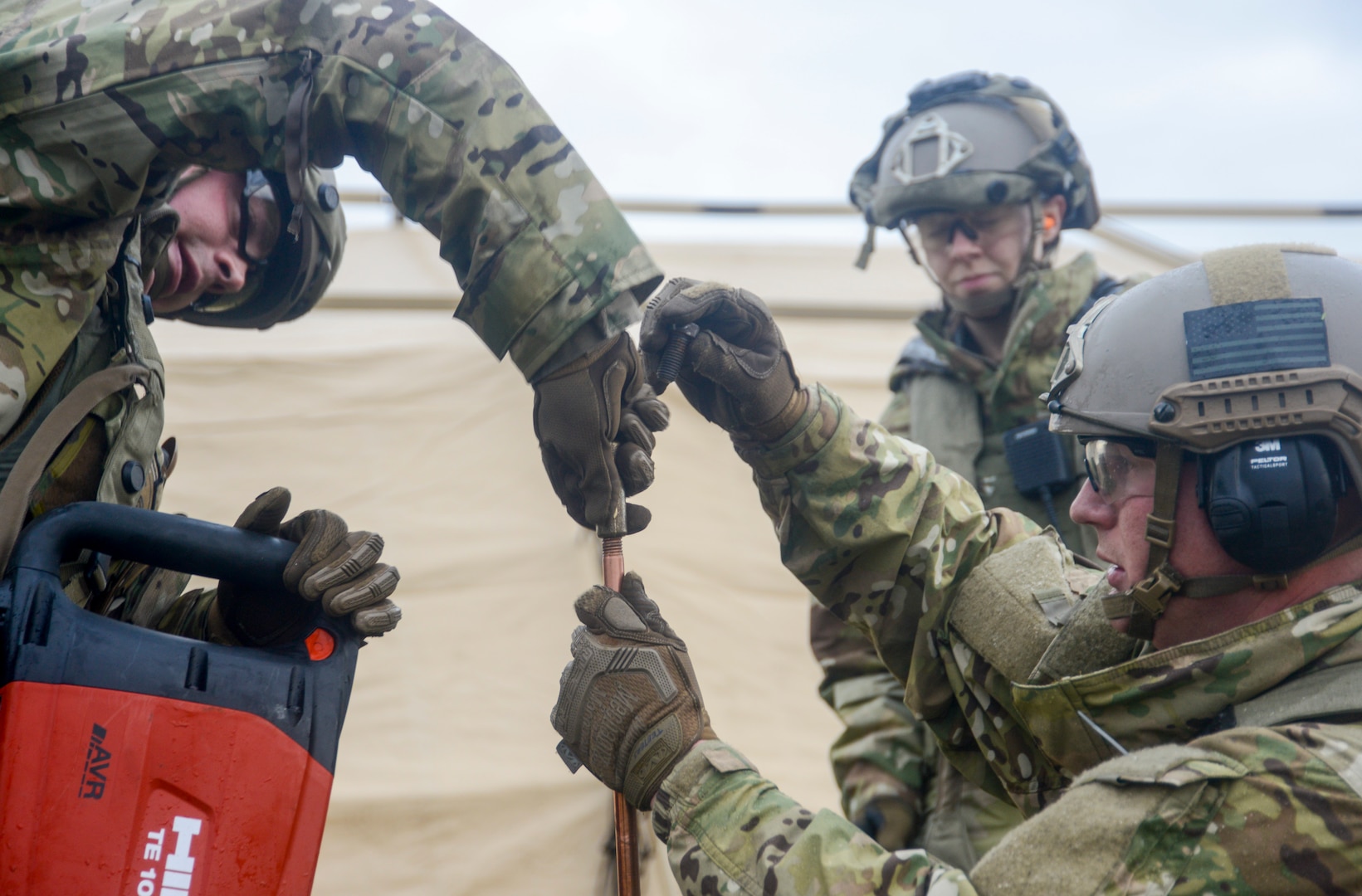 U.S. Airmen assigned to the 435th Contingency Response Group, 435th Air Ground Operations Wing, Ramstein Air Base, Germany, install a grounding point for the electricity during exercise Contested Forge on Grostenquin Air Base, France, Dec. 3, 2018. As part of Contested Forge, Airmen assigned to the 435th CRG practiced their capability to set up, conduct, and defend austere airfield operations and a bare base. (U.S. Air Force photo by Staff Sgt. Timothy Moore)