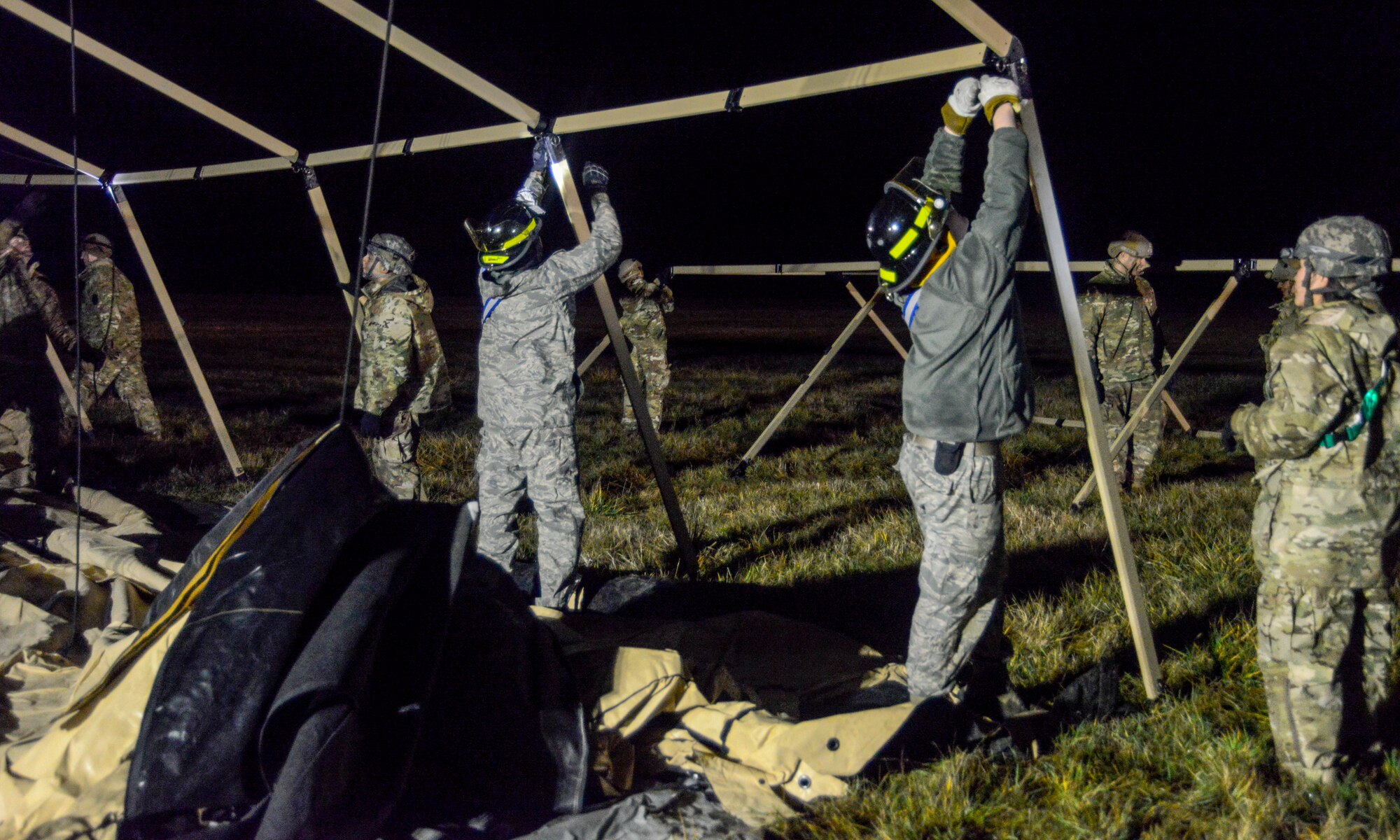 U.S. Airmen assigned to the 435th Contingency Response Group, 435th Air Ground Operations Wing, Ramstein Air Base, Germany, and other organizations build a Tent Model 60 during exercise Contested Forge on Grostenquin Air Base, France, Dec. 3, 2018. As part of Contested Forge, Airmen assigned to the 435th CRG practiced their capability to set up, conduct, and defend austere airfield operations and a bare base. (U.S. Air Force photo by Staff Sgt. Timothy Moore)