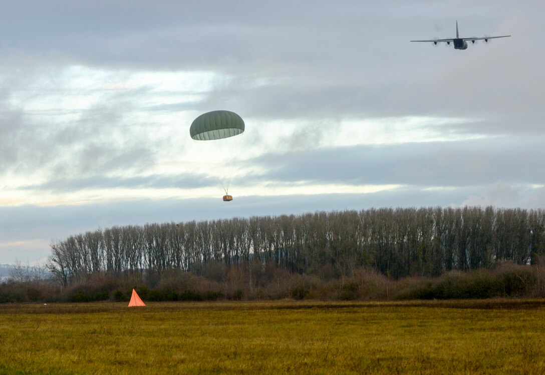 A C-130J Super Hercules aircraft assigned to the 37th Airlift Squadron, 86th Airlift Wing, Ramstein Air Base, Germany, drops a container delivery system during exercise Contested Forge over Grostenquin Air Base, France, Dec. 4, 2018. Contested Forge is an annual exercise that tests the 435th Contingency Response Group’s ability to build a forward operating base and conduct airfield operations in an austere environment, friendly or hostile. (U.S. Air Force photo by Staff Sgt. Timothy Moore)