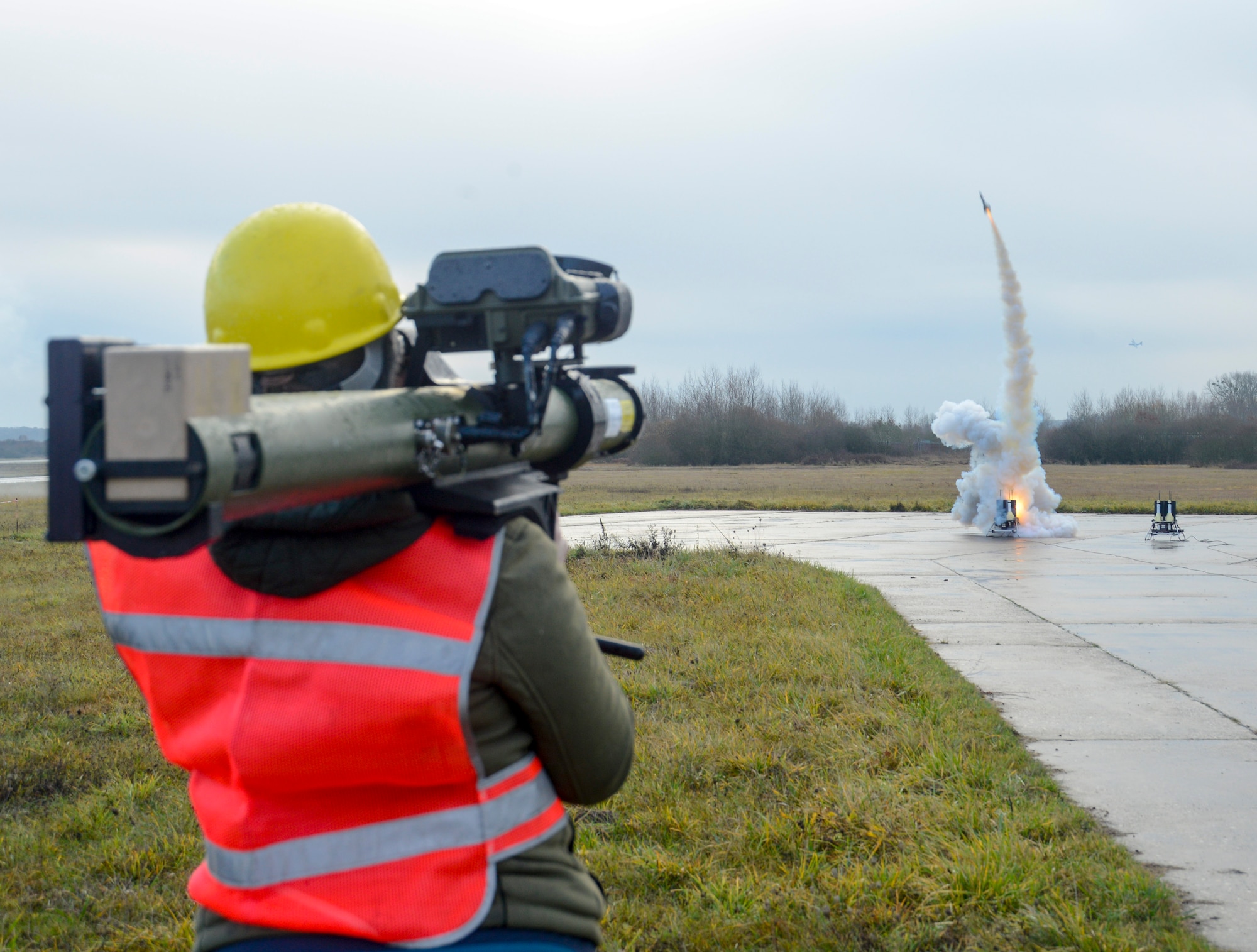 A Polygone employee uses a man-portable aircraft survivability trainer, or MAST, and a smoky surface-to-air missile to simulate enemy fire for the aircrew of a C-130J Super Hercules aircraft assigned to the 37th Airlift Squadron, 86th Airlift Wing, Ramstein Air Base, Germany, during exercise Contested Forge on Grostenquin Air Base, France, Dec. 4, 2018. Contested Forge is an annual exercise that tests the 435th Contingency Response Group’s ability to build a forward operating base and conduct airfield operations in an austere environment, friendly or hostile. (U.S. Air Force photo by Staff Sgt. Timothy Moore)