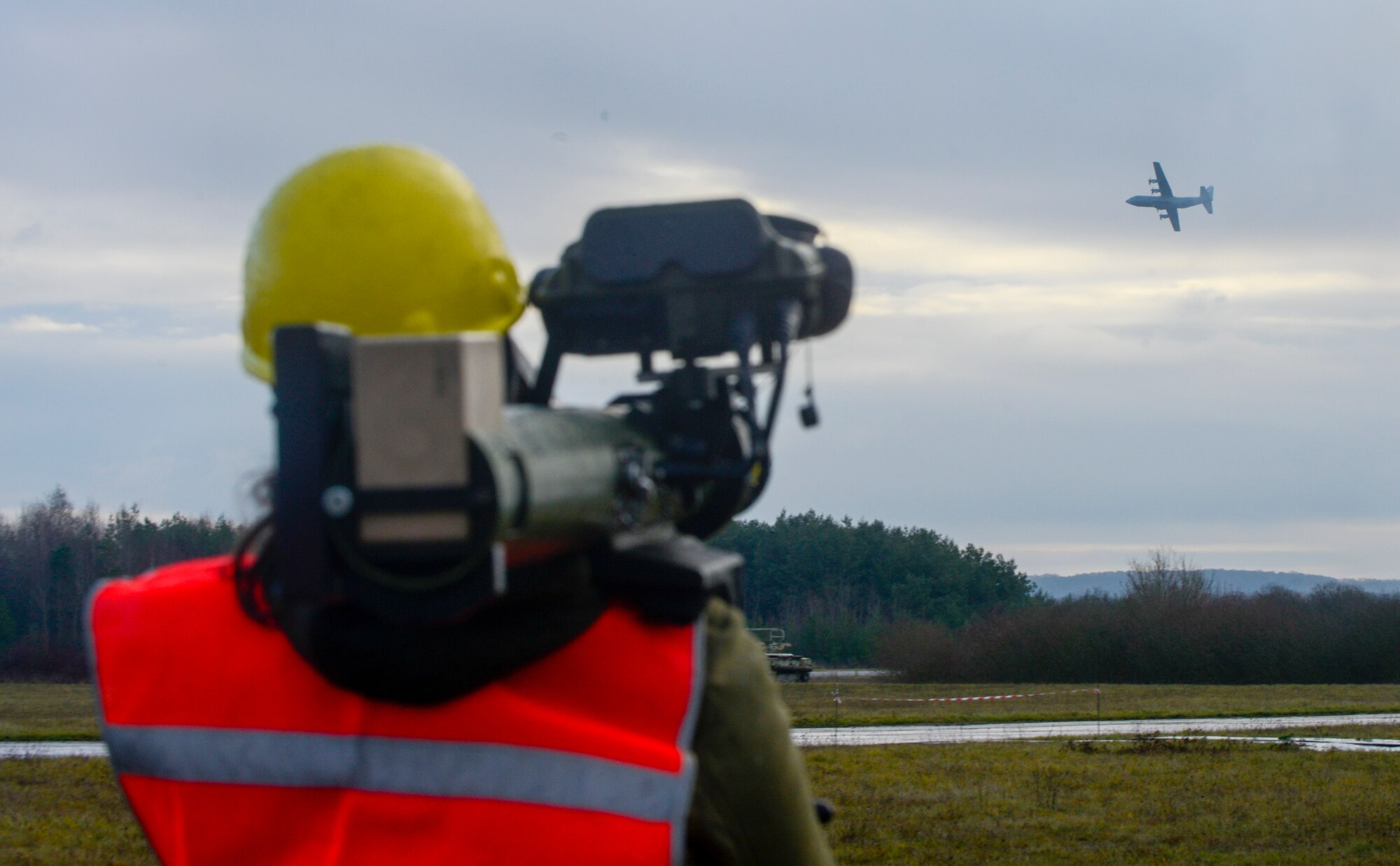 A Polygone employee uses a man-portable aircraft survivability trainer, or MAST, to simulate enemy fire for the aircrew of a C-130J Super Hercules aircraft assigned to the 37th Airlift Squadron, 86th Airlift Wing, Ramstein Air Base, Germany, during exercise Contested Forge on Grostenquin Air Base, France, Dec. 4, 2018. Contested Forge is an annual exercise that tests the 435th Contingency Response Group’s ability to build a forward operating base and conduct airfield operations in an austere environment, friendly or hostile. (U.S. Air Force photo by Staff Sgt. Timothy Moore)