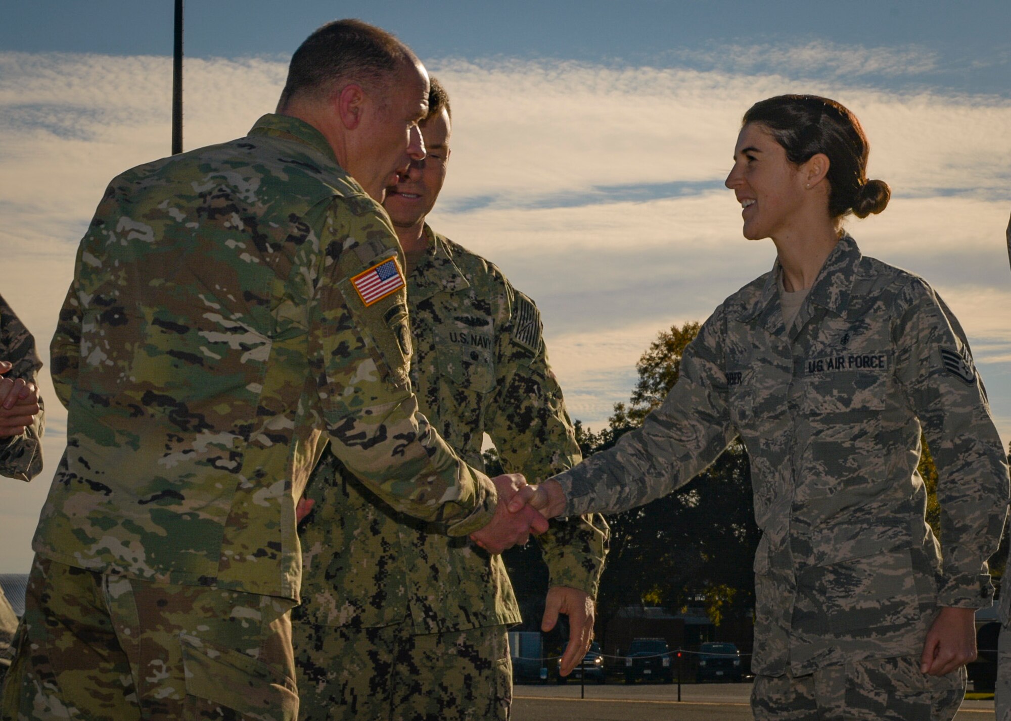 Army Gen. Stephen Lyons, commander of U.S. Transportation Command, presents his official coin to Air Force Staff Sgt. Samantha Webber, 628th Medical Group mental health supervisor, Dec. 6, 2018, at Joint Base Charleston, S.C.