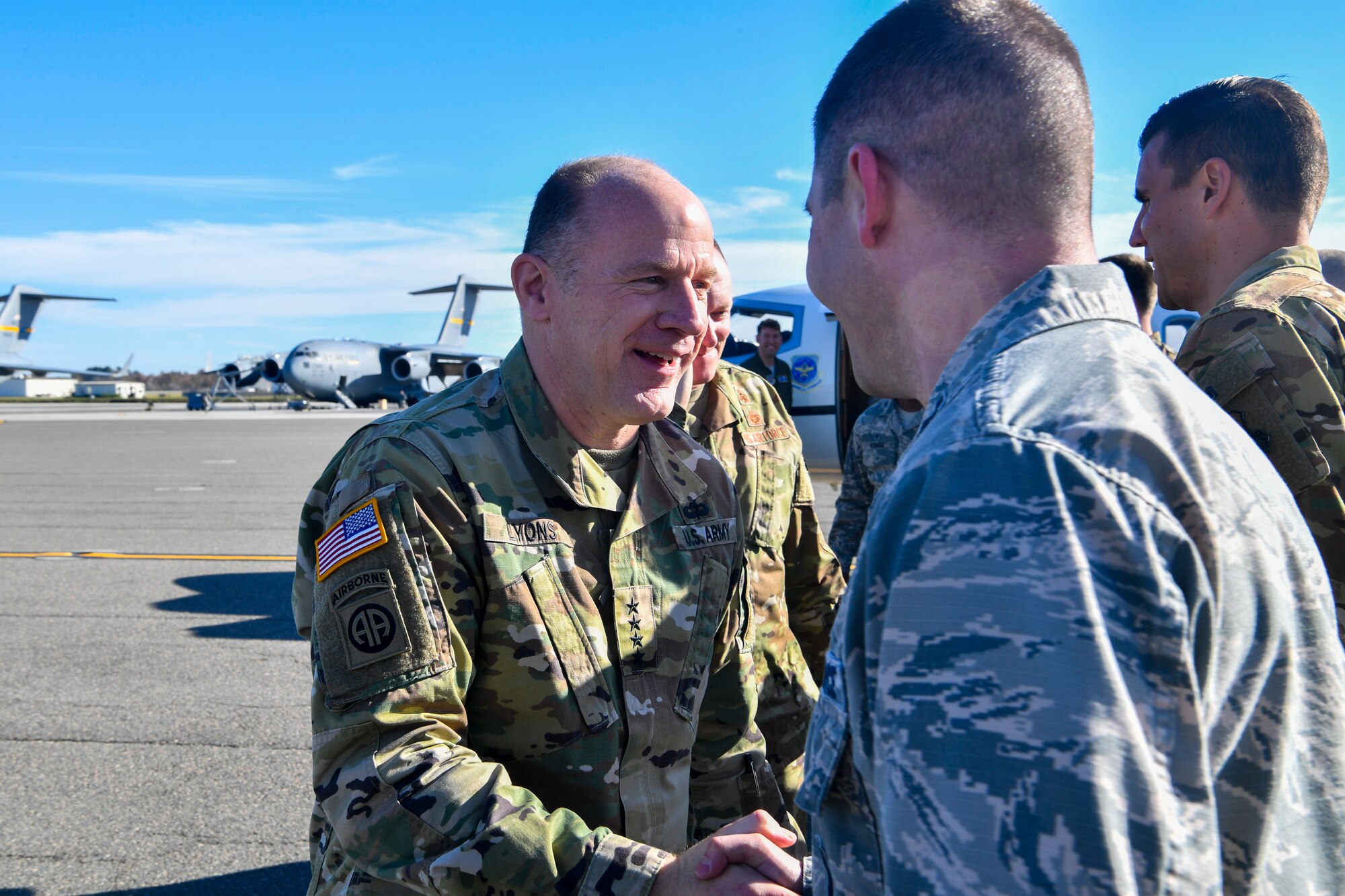 Army Gen. Stephen Lyons, commander of U.S. Transportation Command, greets Air Force Capt. Shawn Cameron, 628th Logistics Readiness Squadron operations officer and lead coordinator for the visit, upon arriving at Joint Base Charleston, S.C., Dec. 6, 2018.