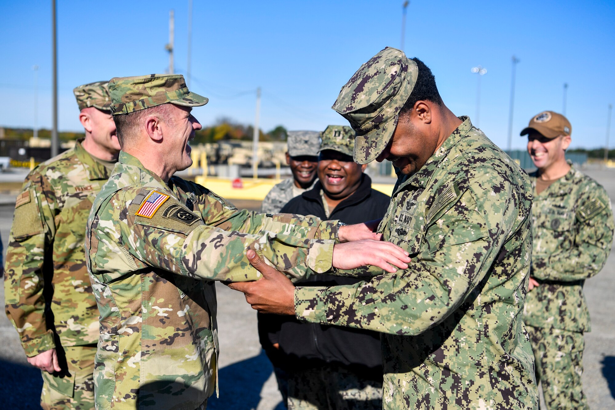 Army Gen. Stephen Lyons, commander of U.S. Transportation Command, laughs with Navy aviation boatswains mate fuels 1st Class Joan Abreu, assigned to the 628th Logistics Readiness Squadron port operations, Dec. 6, 2018, at Joint Base Charleston, S.C.