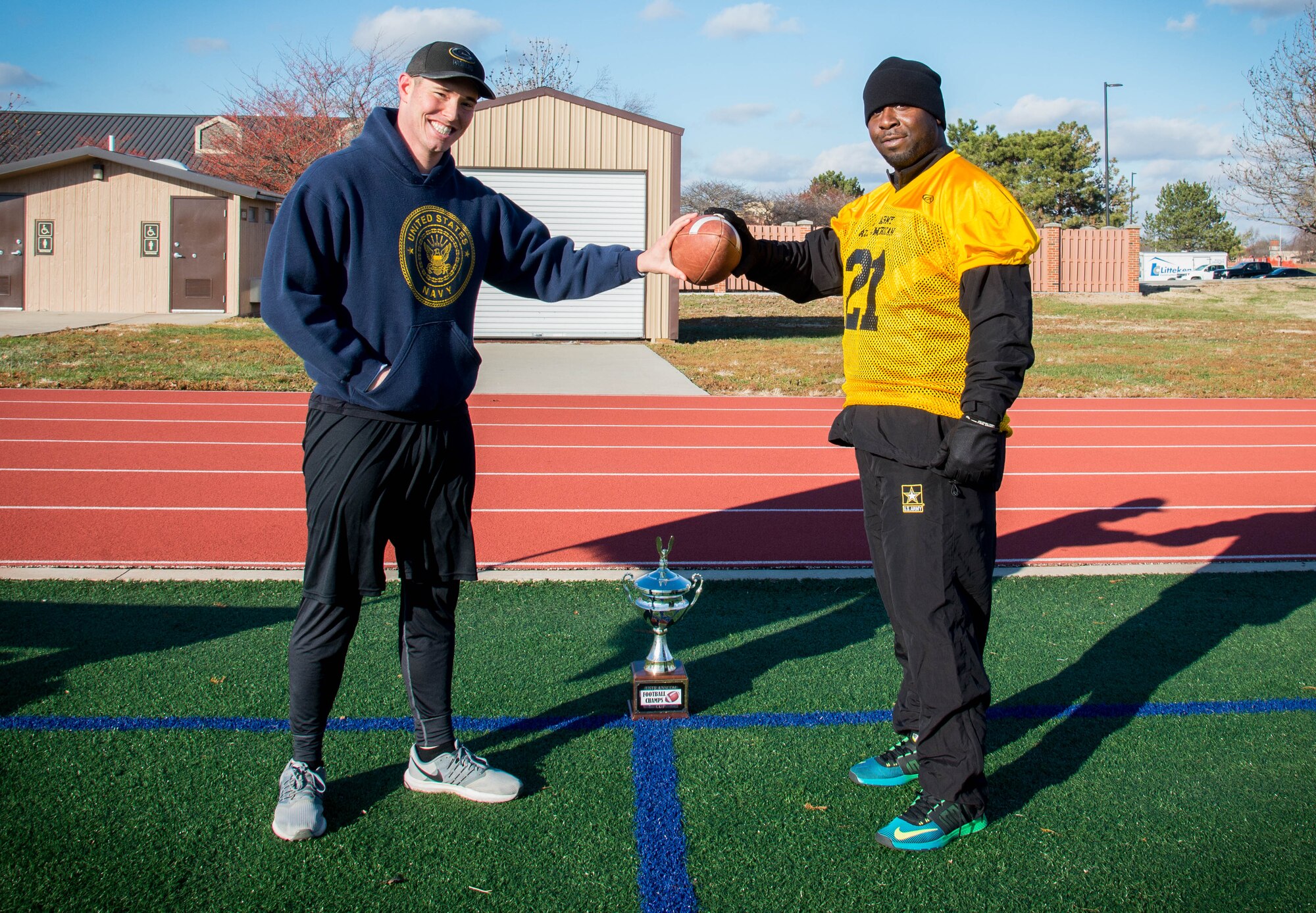 Petty Officer 1st Class Christopher Sowards, U.S. Transportation Command J5/J4 lead system administrator, and Army Staff  Sgt. Anton Smith, USTRANSCOM transportation coordinator, prepare for an Army vs. Navy football game at Scott Air Force Base, Illinois, Nov. 26, 2018. The Army-Navy game stems from the huge rivalry between the two service academies since 1890.
