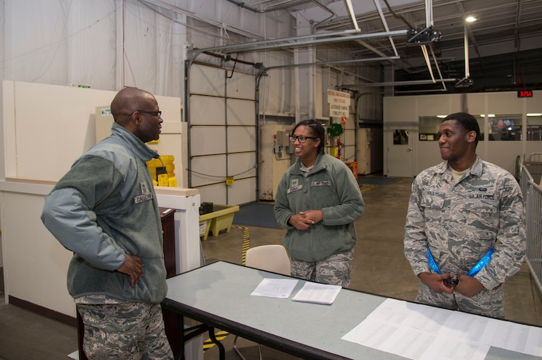 Chief Master Sgt. Leon Calloway, 375th Air Mobility Wing command chief, speaks to Airman 1st Class Lastiwa Hall 375th Force Support Squadron customer support tecnician and Staff Sgt. Shenisha Dunn, 375th Force Support Squadron during the mobility exercise at Scott AFB, Ill. Dec. 3, 2018. During the exercise Calloway visited with multiple Airmen around Scott to see the different missions involved in the exercise.