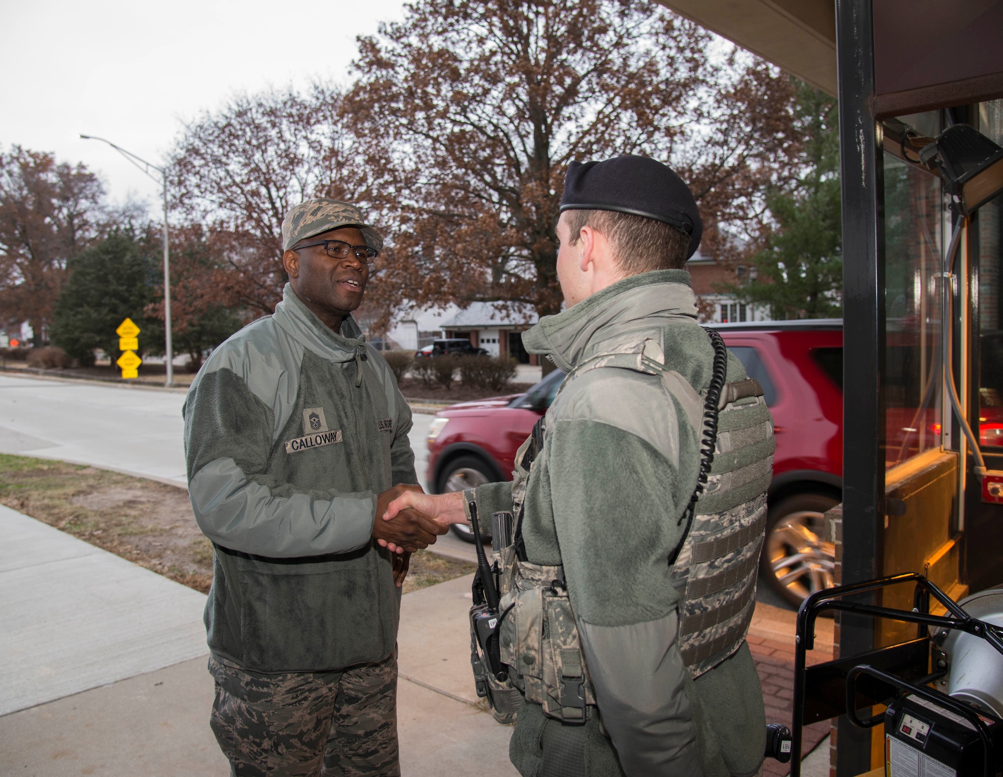 Chief Master Sgt. Leon Calloway, 375th Air Mobility Wing command chief shakes hands with Airman 1st Class John Fields, 375th Security Forces Squadron during a post check, Dec. 3, 2018 at Scott AFB, Ill. Dec. 3, 2018. During the Mobility Exercise Calloway visited with members of the 375th SFS to thank them for the work they do around the base.