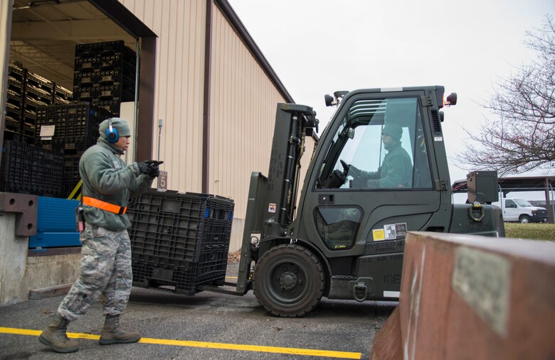 Airman 1st Class Weslee Anderson, 375th Logistics Readiness Squadron fuels distribution operator, and Airman 1st Class Eliezer Riviera, 375th LRS ground transportation, load pallets into the LRS warehouse during a mobility exercise, Dec. 4, 2018, at Scott Air Force Base, Illinois. During the mobility exercise, Airmen were tested on their ability to deploy at a moment’s notice.