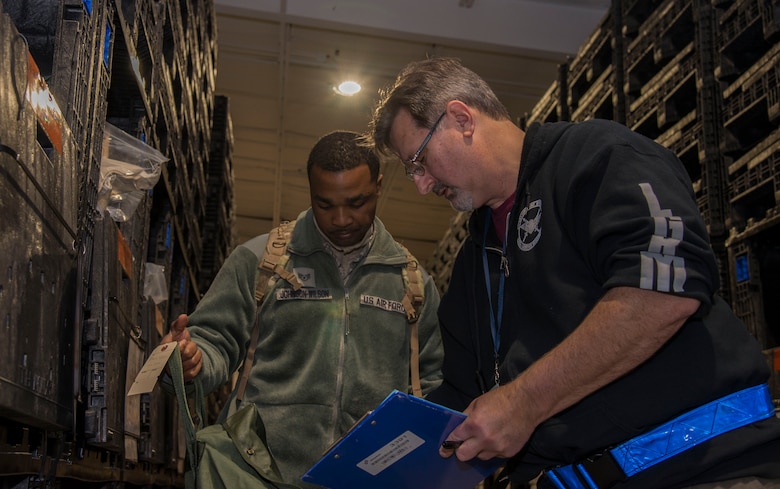 Staff Sgt. Anthony Johnson-Wilson, 436th Supply Chain Operations Squadron, is given deployment equipment during a mobility exercise, Dec. 4, 2018, at Scott Air Force Base, Illinois. During the first phase of the exercise, deploying Airmen are issued a flak vest, helmets, and other necessary gear required for deployment.