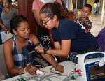 Hospital Corpsman 3rd Class Michelle Sheldrew, from Mundelein, Ill. takes a patient’s blood pressure at one of two medical sites.