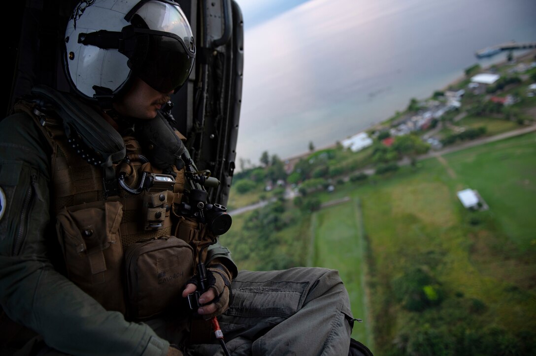 Naval Aircrewman (Helicopter) 2nd Class Connor McSpadden, from Charlette, N.C., conducts a survey of the Honduran airspace in preparation for vertical replenishment operations from aboard an MH-60S Seahawk, assigned to the “Sea Knights” of Helicopter Sea Combat Squadron (HSC) 22.
