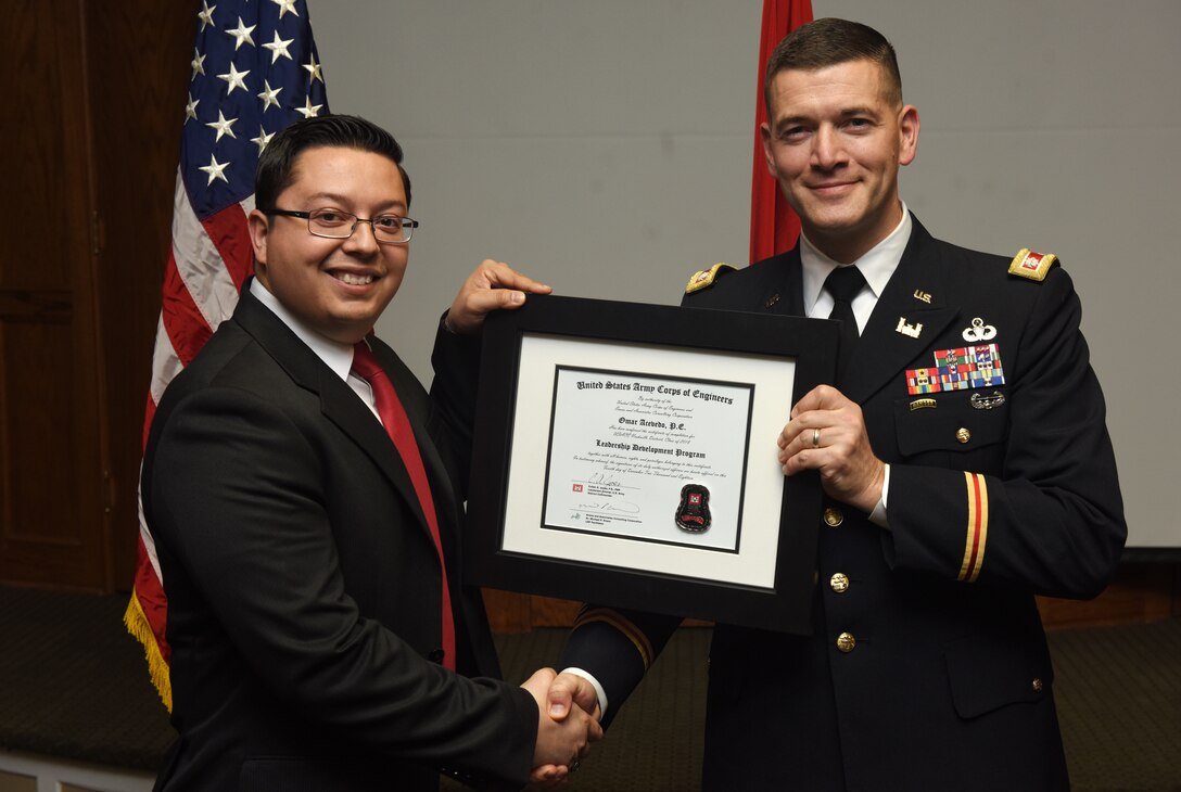 Lt. Col. Cullen Jones, U.S. Army Corps of Engineers Nashville District commander, presents a graduation diploma for the 2018 Leadership Development Program Level II Course to Omar Acevedo during a graduation ceremony Dec. 4, 2018 at the Scarritt Bennett Center in Nashville, Tenn. (USACE Photo by Lee Roberts)