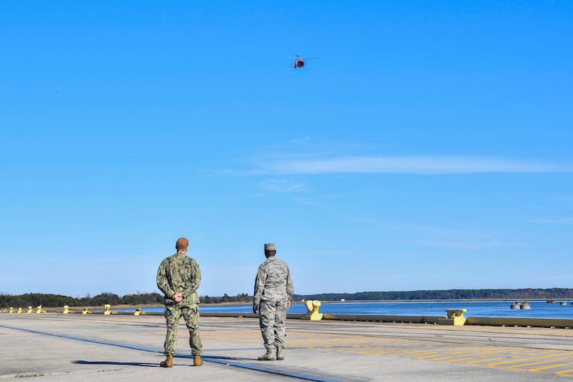 Air Force Col. Terrence Adams, right, Joint Base Charleston commander, and Master Chief Petty Officer Jonathan Lonsdale, Naval Support Activity Charleston command master chief, await the arrival of Army Gen. Stephen Lyons, commander of U.S. Transportation Command, at the Naval Weapons Station Dec. 6, 2018, at Joint Base Charleston, S.C.