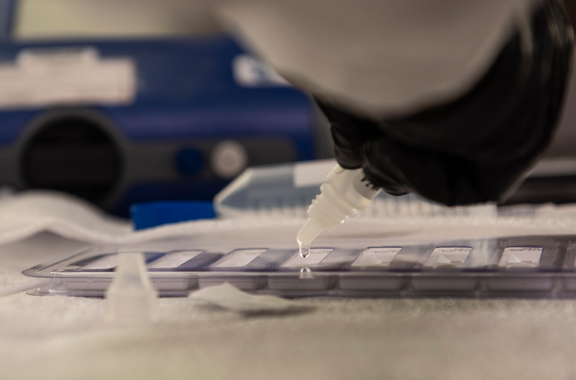 Airman William Wang, 375th Aerospace Medicine Squadron bioenvironmental engineering technician, uses a dropper filled with a combination of buffer solution and a simulated suspected contaminant during a training exercise on Nov. 29, 2018, at Scott Air Force Base. Wang applied the dropper to a hand held assay which gives the presumptive result of eight different biological agents. The buffer solution and HHA are then sent to a lab for results.