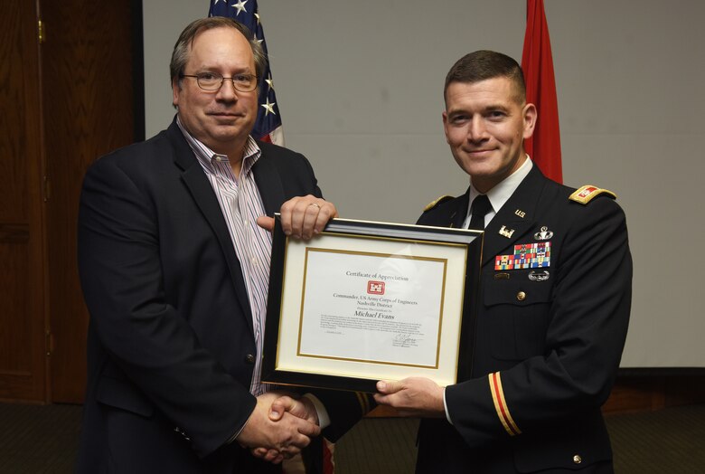 Lt. Col. Cullen Jones, U.S. Army Corps of Engineers Nashville District Commander, presents the Department of the Army Achievement Medal for Civilian Service to Travis A. Wiley, assistant program coordinator of the Nashville District’s Leadership Development Program Level II Course, for his initiative in developing program contract requirements, organizing program schedules, making logistical arrangements for class sessions during the program’s graduation ceremony Dec. 4, 2018 at the Scarritt Bennett Center in Nashville, Tenn. (USACE Photo by Lee Roberts)