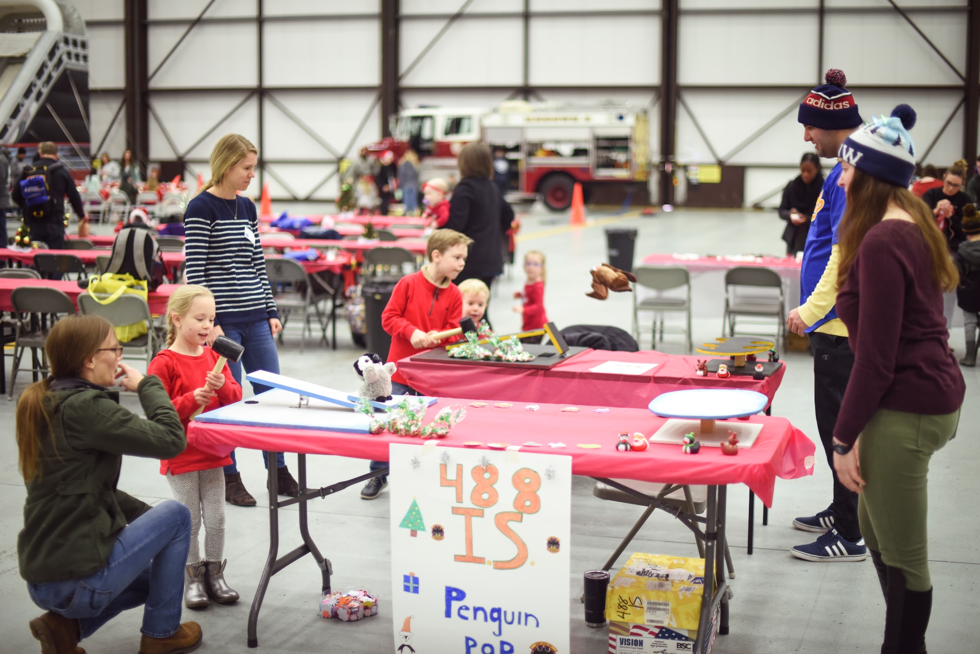 Volunteers from the 488th Intelligence Squadron help Team Mildenhall children launch plush dolls from platforms during the annual Children’s Holiday Party at RAF Mildenhall, England, Dec. 8, 2018. The Mildenhall Spouses Association hosted the Hearts Apart event, and the annual Children’s Holiday Party for Team Mildenhall families. (U.S. Air Force photo by Tech. Sgt. Emerson Nuñez)