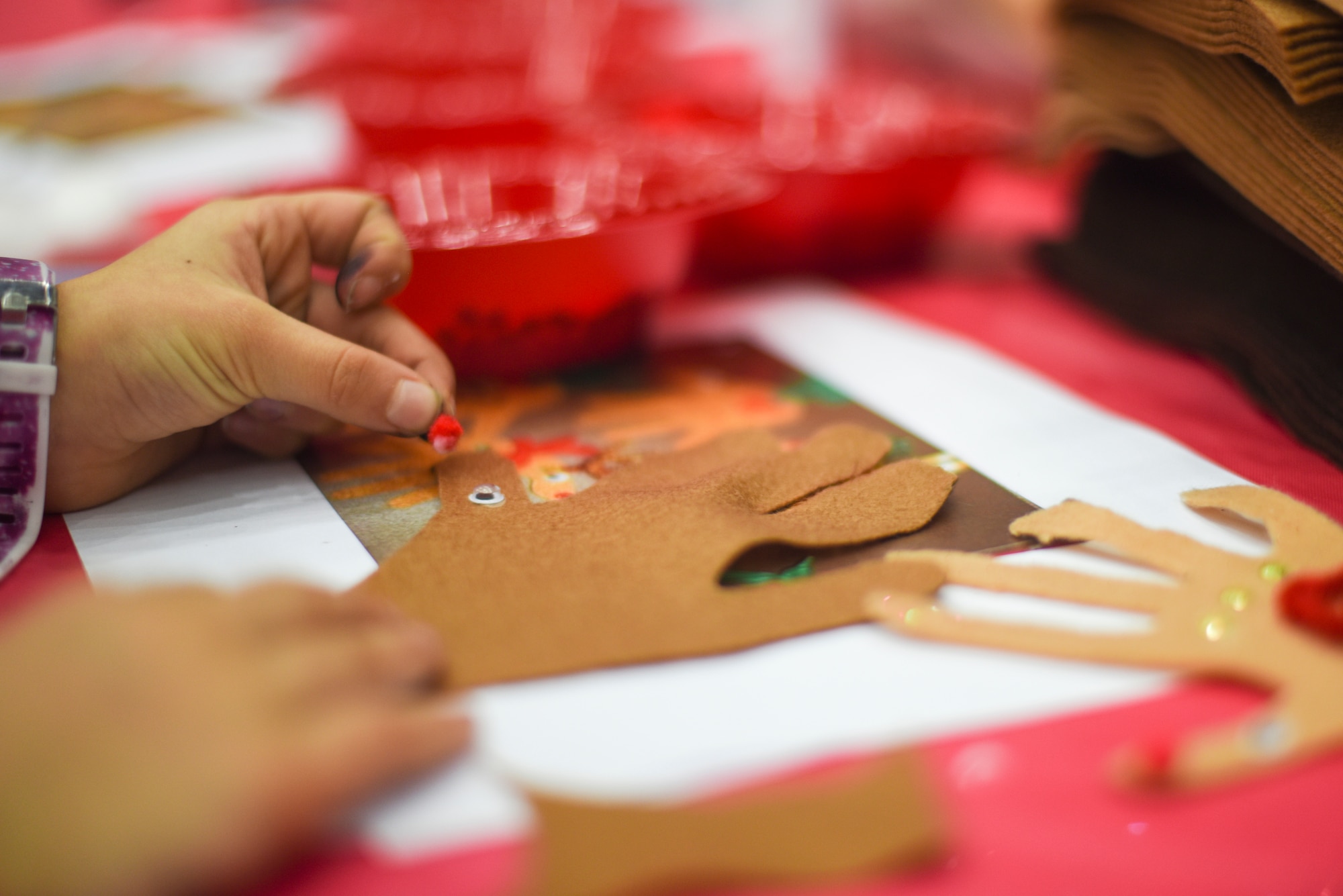 A Team Mildenhall child makes a hand Rudolph during the annual Children’s Holiday Party at RAF Mildenhall, England, Dec. 8, 2018. The Mildenhall Spouses Association hosted the Hearts Apart event, and the annual Children’s Holiday Party for Team Mildenhall families. (U.S. Air Force photo by Tech. Sgt. Emerson Nuñez)