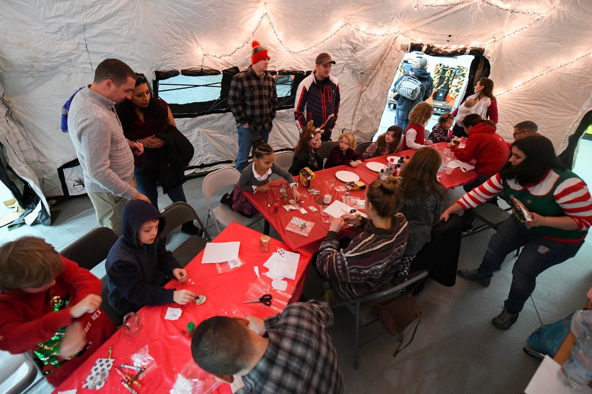 Team Mildenhall volunteers help children with craft projects during the annual Children’s Holiday Party at RAF Mildenhall, England, Dec. 8, 2018. The event provided Team Mildenhall families an opportunity to come together in celebration of the holiday season through games, food and crafts. (U.S. Air Force photo by Tech. Sgt. Emerson Nuñez)