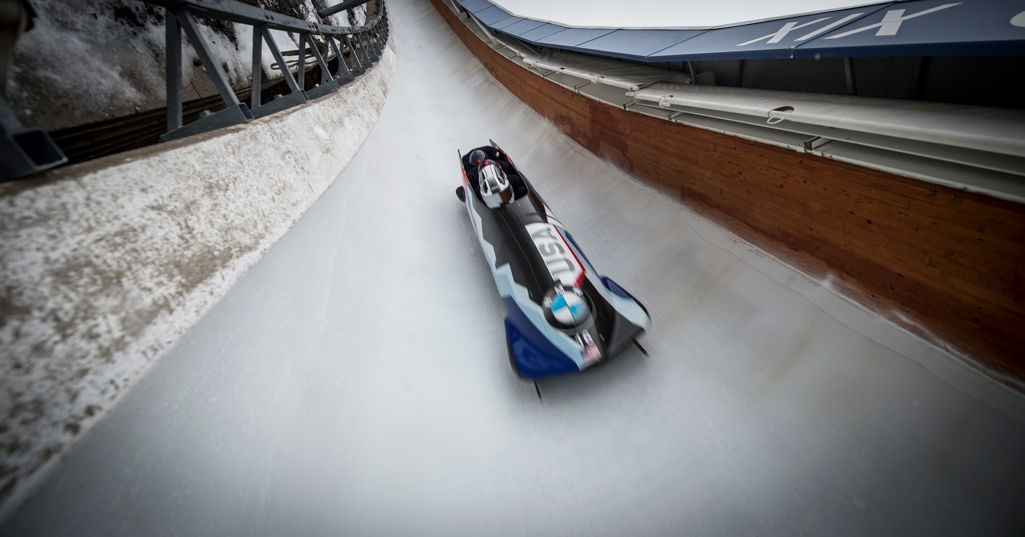 Four people bobsledding