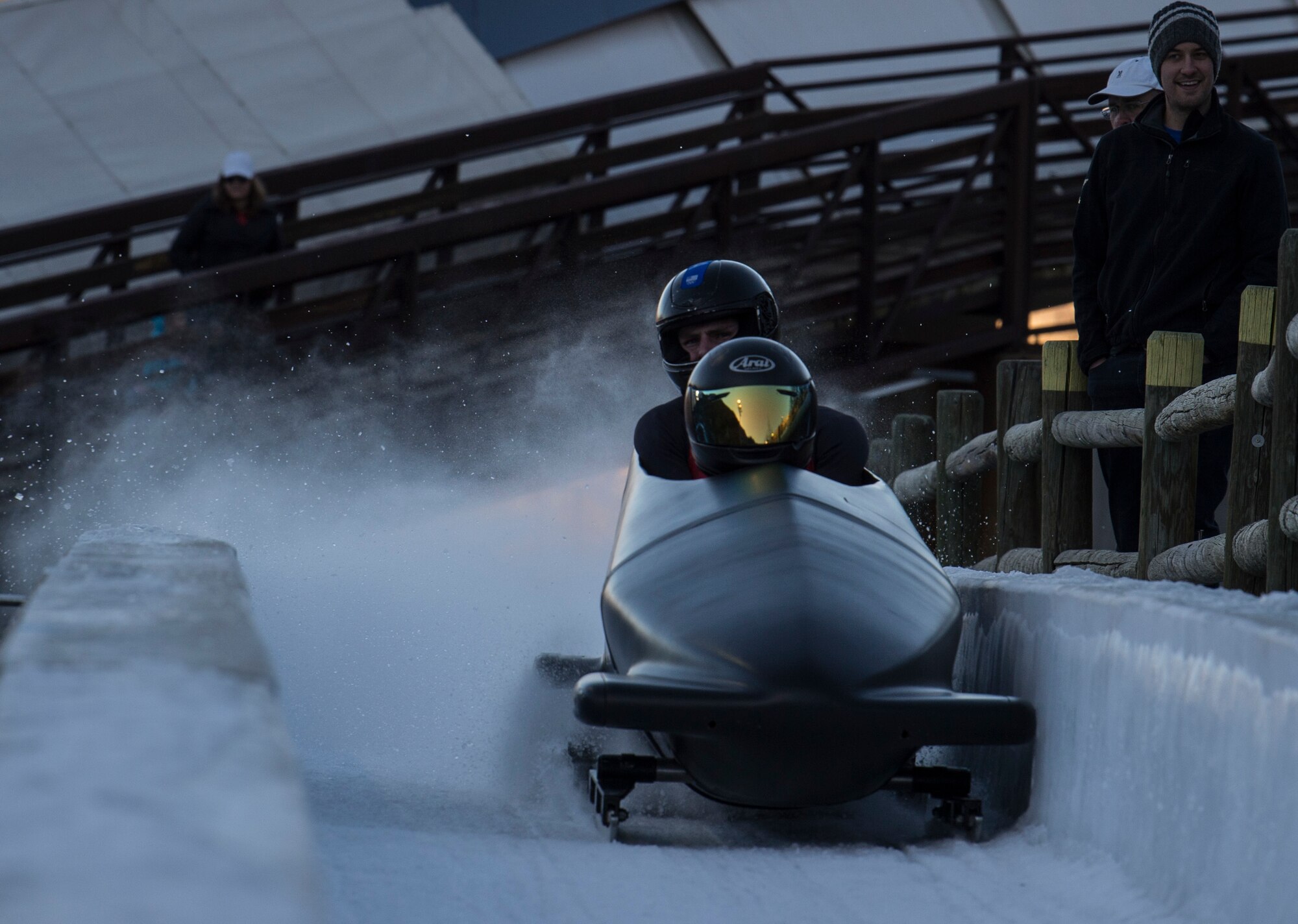 Two people bobsledding.