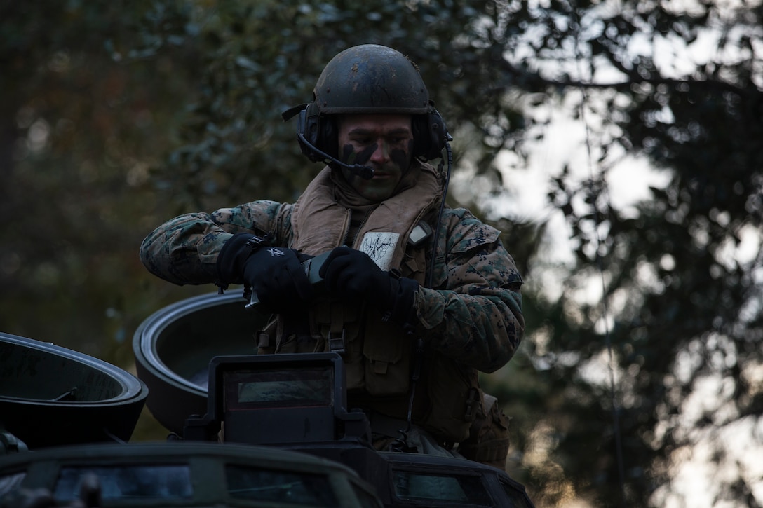 A U.S. Marine with 2nd Assault Amphibian Battalion, 2nd Marine Division, performs a radio check prior to executing river crossing operations during the 6th Marine Regiment field exercise (FEX) aboard Camp Lejeune, N.C., Dec. 7, 2018. The regimental FEX utilizes combat capabilities from across the Marine Air-Ground Task Force, enhancing mission readiness.