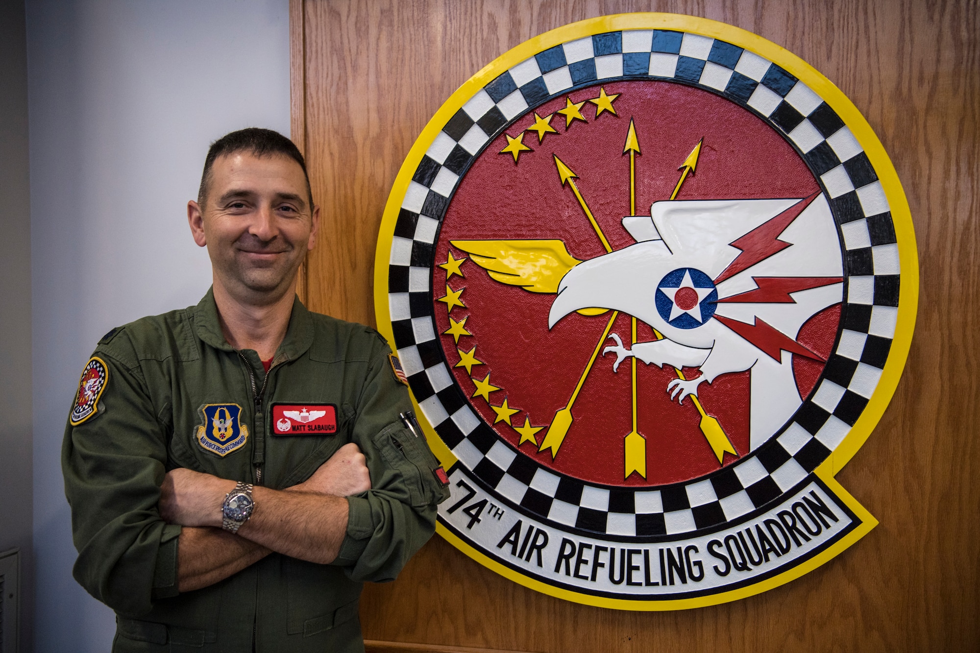 Lt. Col. Matt Slabaugh, 74th Air Refueling Squadron Commander, poses for a photo in front of the 74th ARS seal at Grissom Air Reserve Base, Ind., Nov. 14, 2018. Slabaugh recently took command of the 74th after the retirement of Lt. Col. Brian Burr. (U.S. Air Force photo / Senior Airman Harrison Withrow)