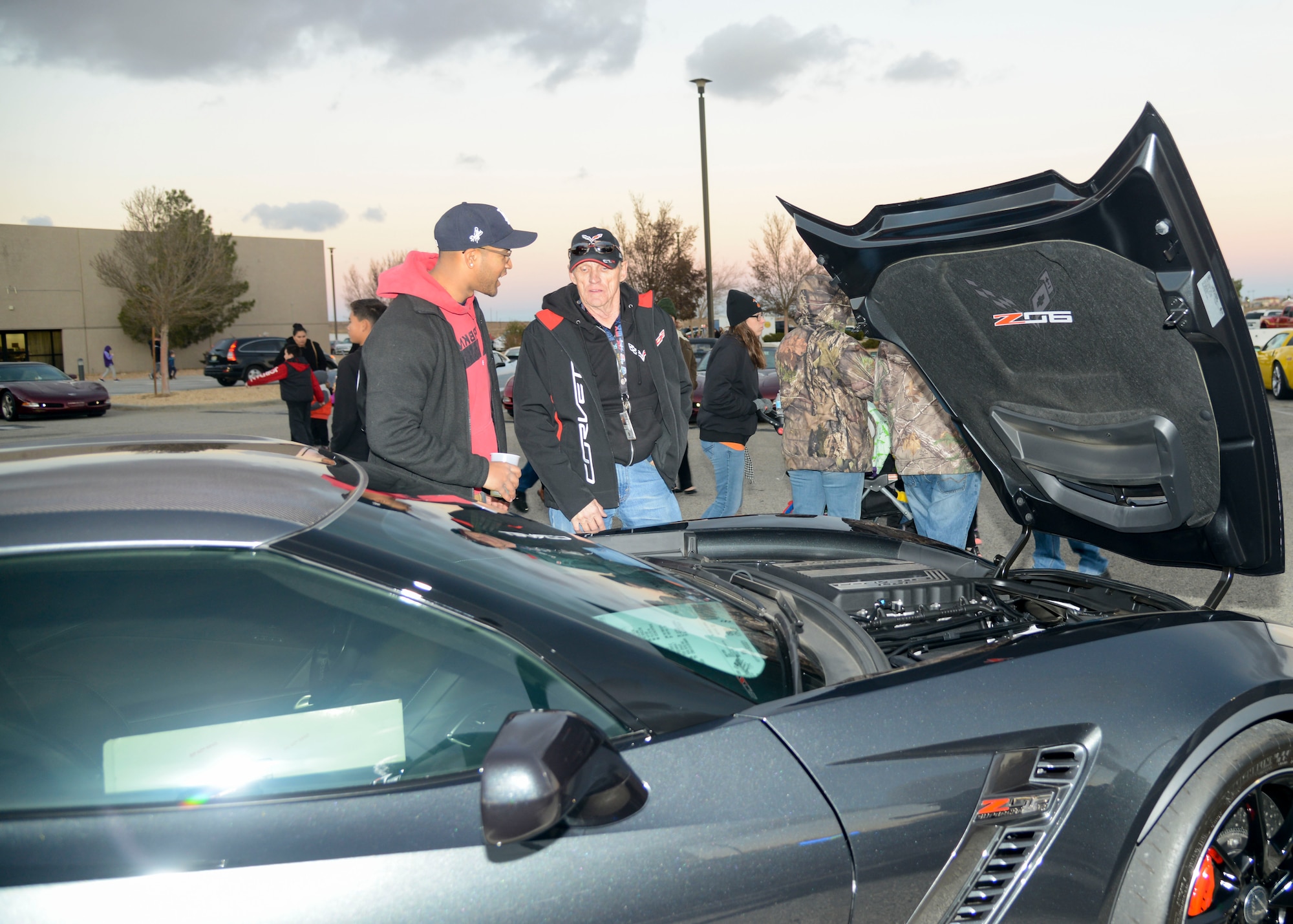 A Team Edwards member discusses cars with a Corvette car club member during the car show portion of Winterfest at Edwards Air Force Base, California, Nov. 30. Winterfest is an annual event that allows members of the community to ring in the start of the holiday season. (U.S. Air Force photo by Giancarlo Casem)
