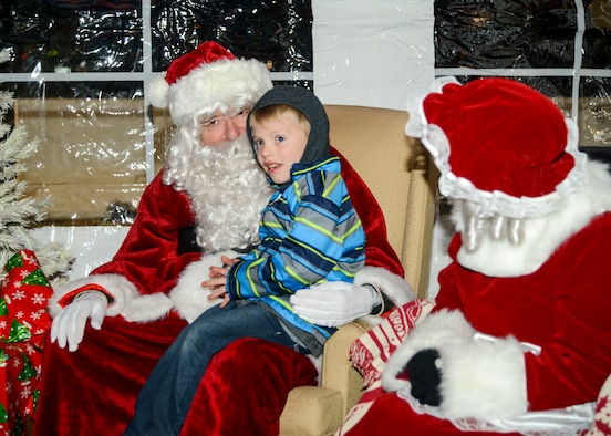 Santa Claus talks to a young member of the Edwards community during Winterfest at Edwards Air Force Base, California, Nov. 30. Winterfest is an annual event that allows members of the community to ring in the start of the holiday season. (U.S. Air Force photo by Giancarlo Casem)