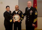 Rear Adm. Tina Davidson, commander of Navy Medicine Education, Training and Logistics Command, and Command Master Chief Petty Officer Richard Putnam, NMETLC, present Petty Officer 1st Class Daniel Guillen, NMTSC hospital corpsman, with a plaque in honor of his selection as NMETLC regional Sailor of the Year Dec 6, 2018, at Joint Base San Antonio-Fort Sam Houston, Texas.